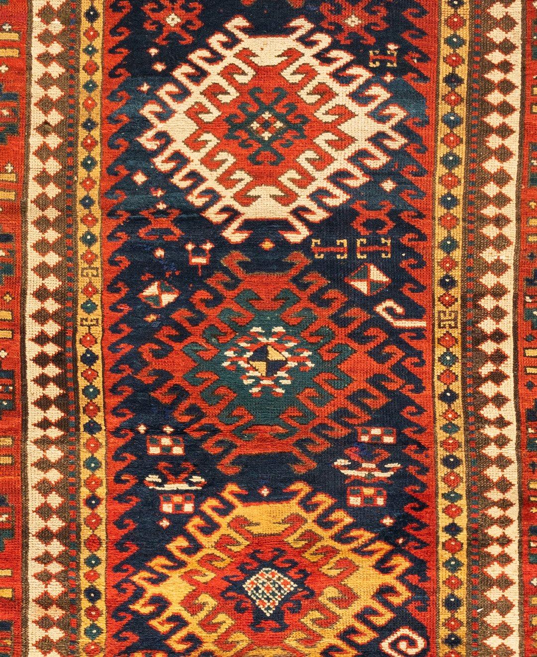 This lovely antique Caucasian Tribal Geometric navy blue Kazak rug measures 4.7 x 8 ft. and is from the 1920s.

  