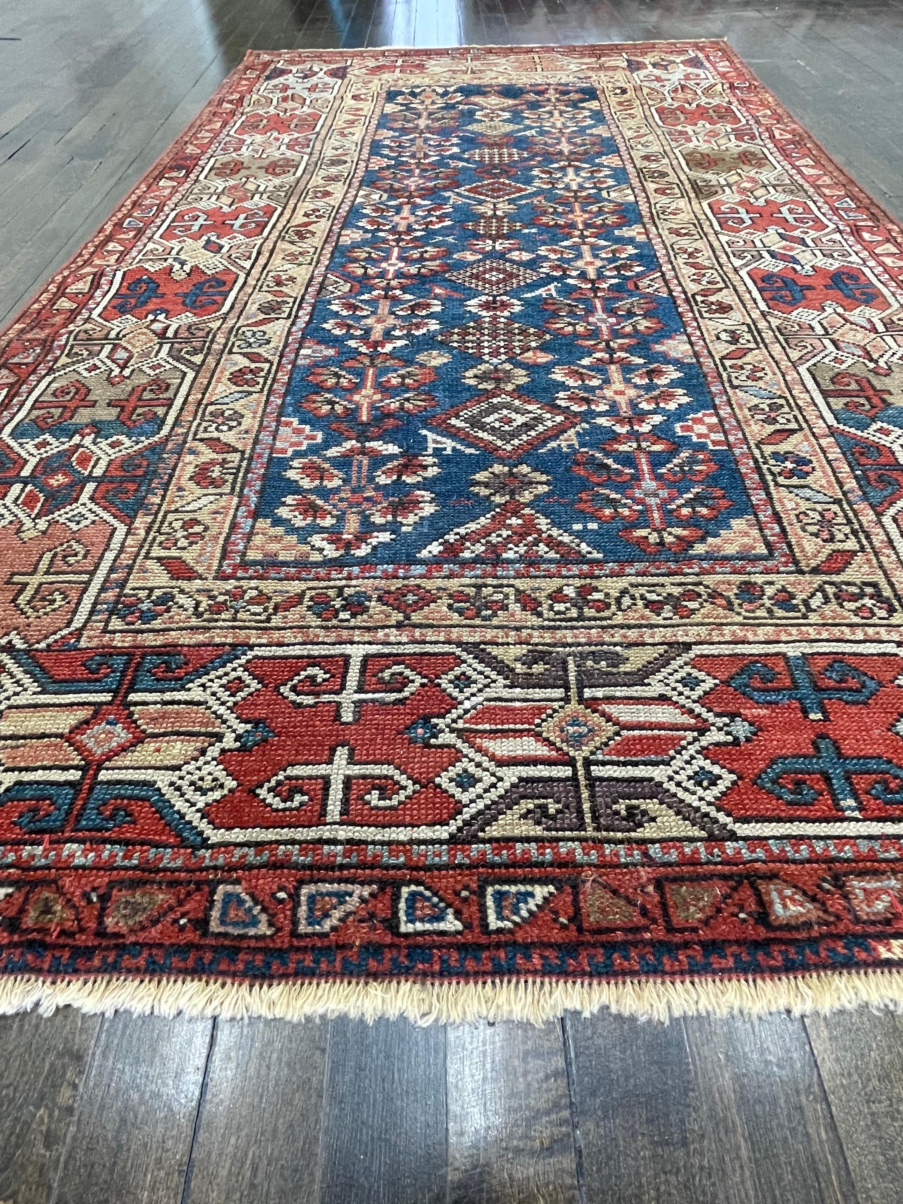 A very attractive piece with splendid color, this rug is attributed to Kazak ,perhaps woven by an individual artist weaver for personal use and not the market. It has a wool warp and weft with neutral brown tone undyed. A wide and well-drowned