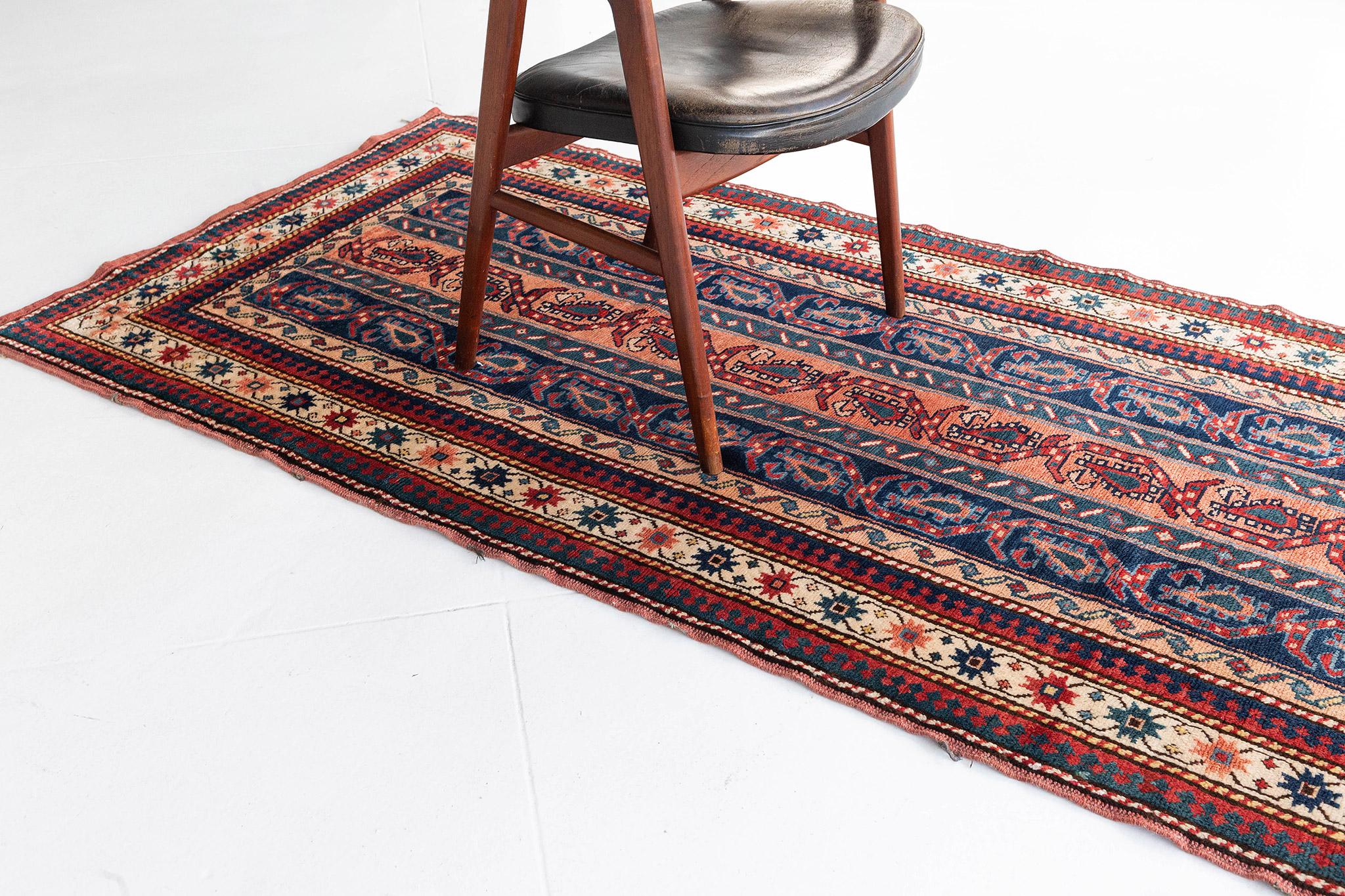 Behold and catch a glimpse of the elegance of the Caucasian Kazak rug from our sought-after collection. Tones of indigo, maroon, and cream featured the alternates and outline details of Caucasian symbols. Furniture that having a boho-chic and even
