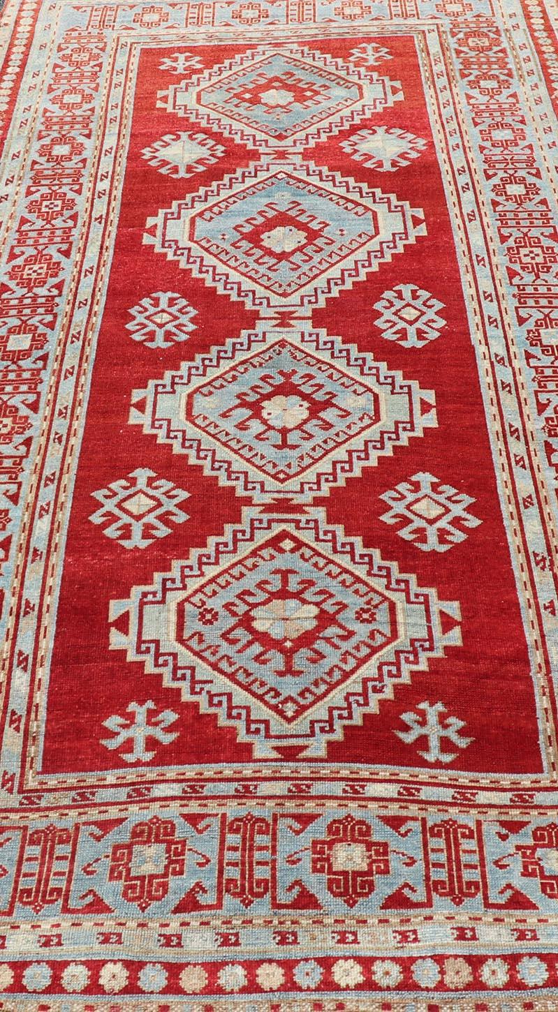 Early 20th Century Antique Caucasian Kazak Gallery Rug in Brilliant Red with Geometric Design For Sale