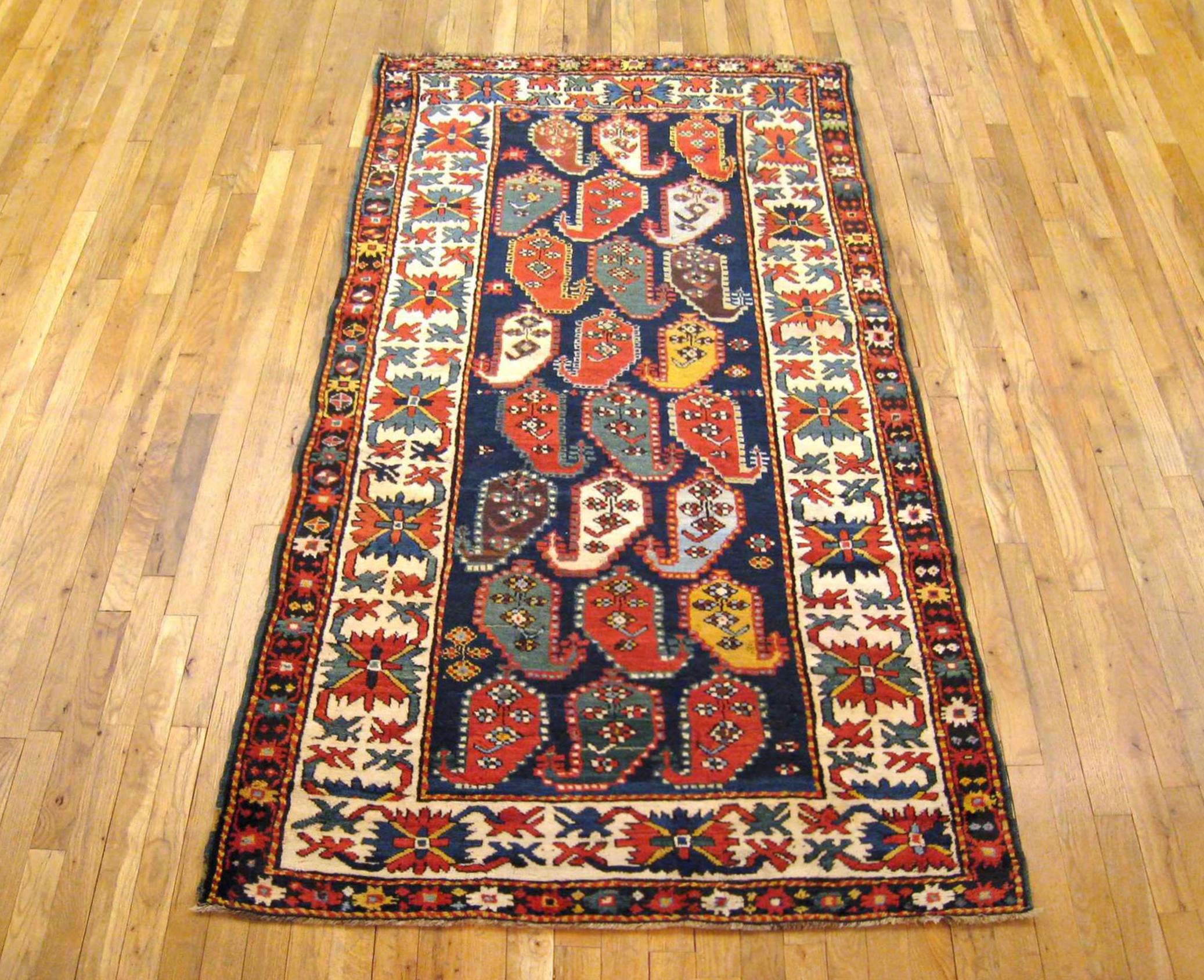 Antique Caucasian Kazak Oriental Carpet, Runner size, circa 1890.

A one-of-a-kind antique Caucasian Kazak Oriental Carpet, hand-knotted with soft wool pile. This lovely hand-knotted wool rug features a Paisley design allover the blue central