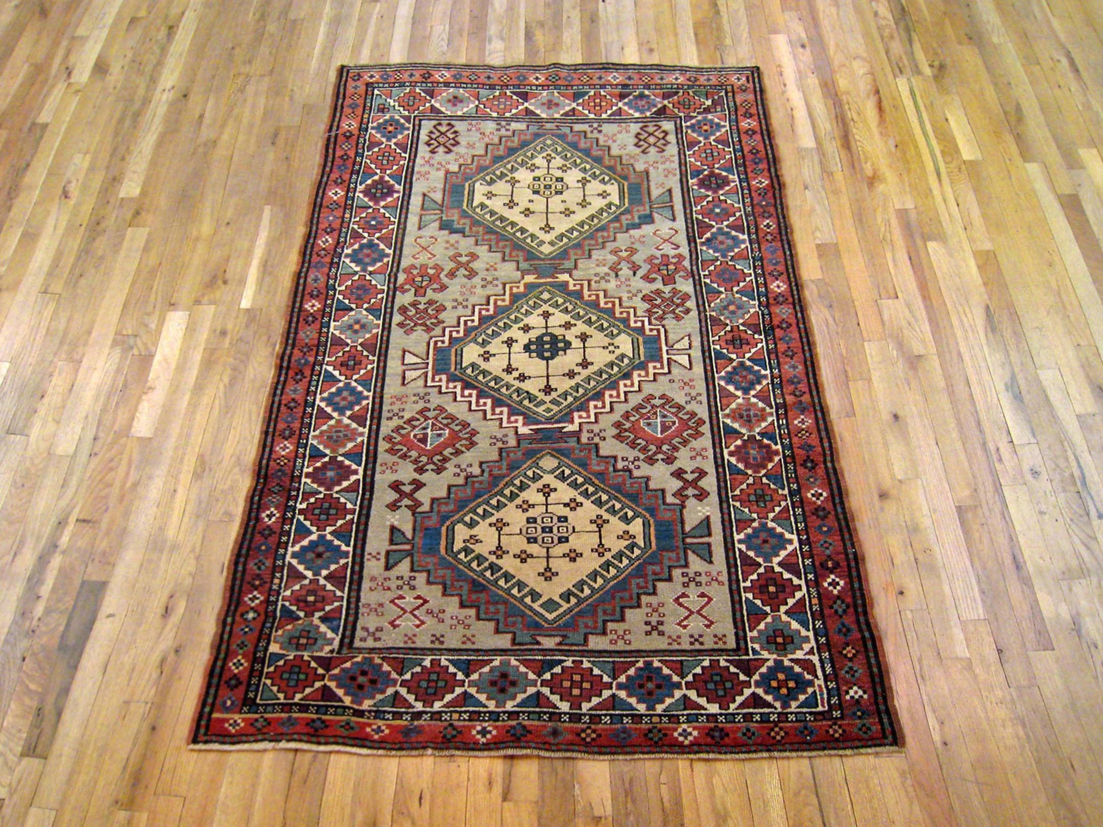Antique Caucasian Kazak Oriental Carpet, Small size, circa 1900

A one-of-a-kind antique Caucasian Kazak Oriental Carpet, hand-knotted with soft wool pile. This lovely hand-knotted wool rug features three medallions with geometric abstracts on the
