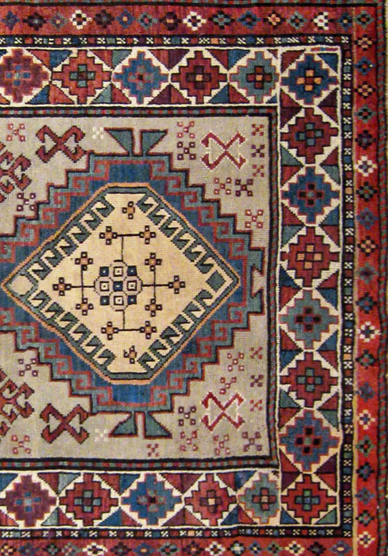 Hand-Knotted Antique Caucasian Kazak Oriental Rug in Small Size with Three Medallions  For Sale