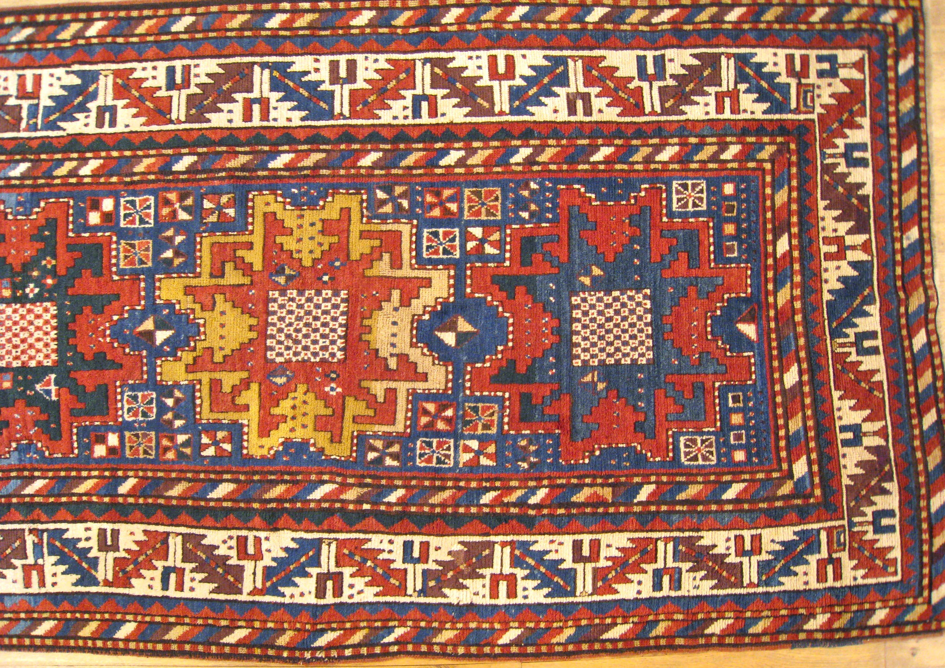 Hand-Knotted Antique Caucasian Kazak Oriental Rug, Small Size, Starburst Design & Blue Field For Sale