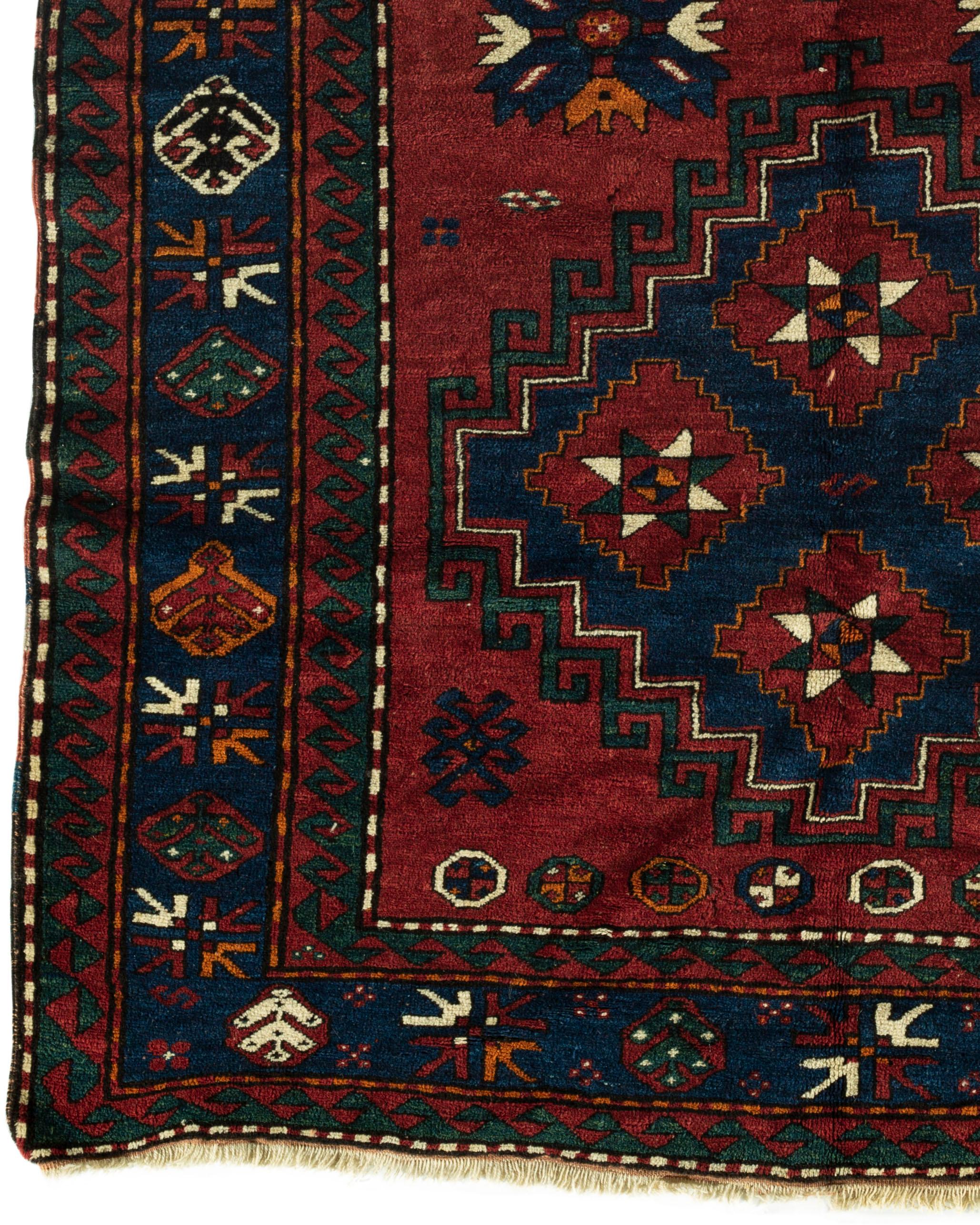 Antique Caucasian Kazak rug, circa 1890. A south west Caucasian Kazak hand woven rug circa 1890. Two large central motifs on a red ground with ethnic designs surrounded by multiple borders that is traditional in these Caucasian weavings. The