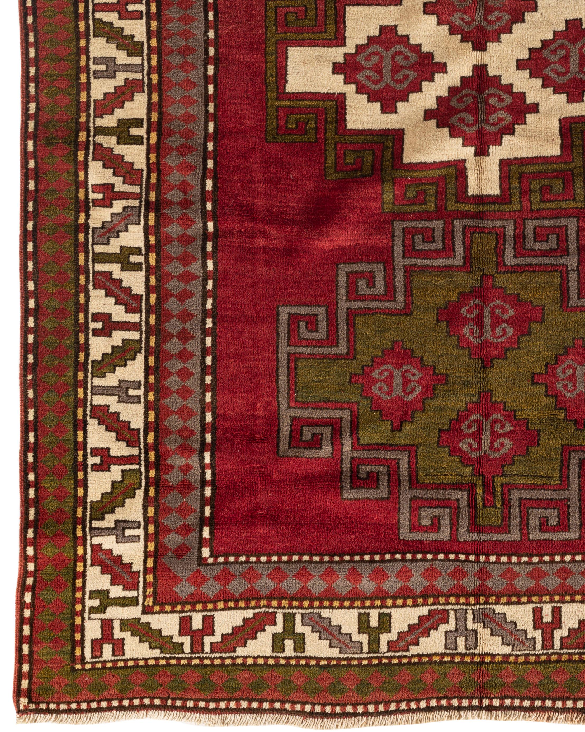 Antique Caucasian Kazak rug, circa 1900. A south west Caucasian Kazak handwoven rug circa 1900, with a bold design of three medallions, that create a true sense of beauty, to this tribal piece. The Caucasus Mountains, between Persia and Russia are