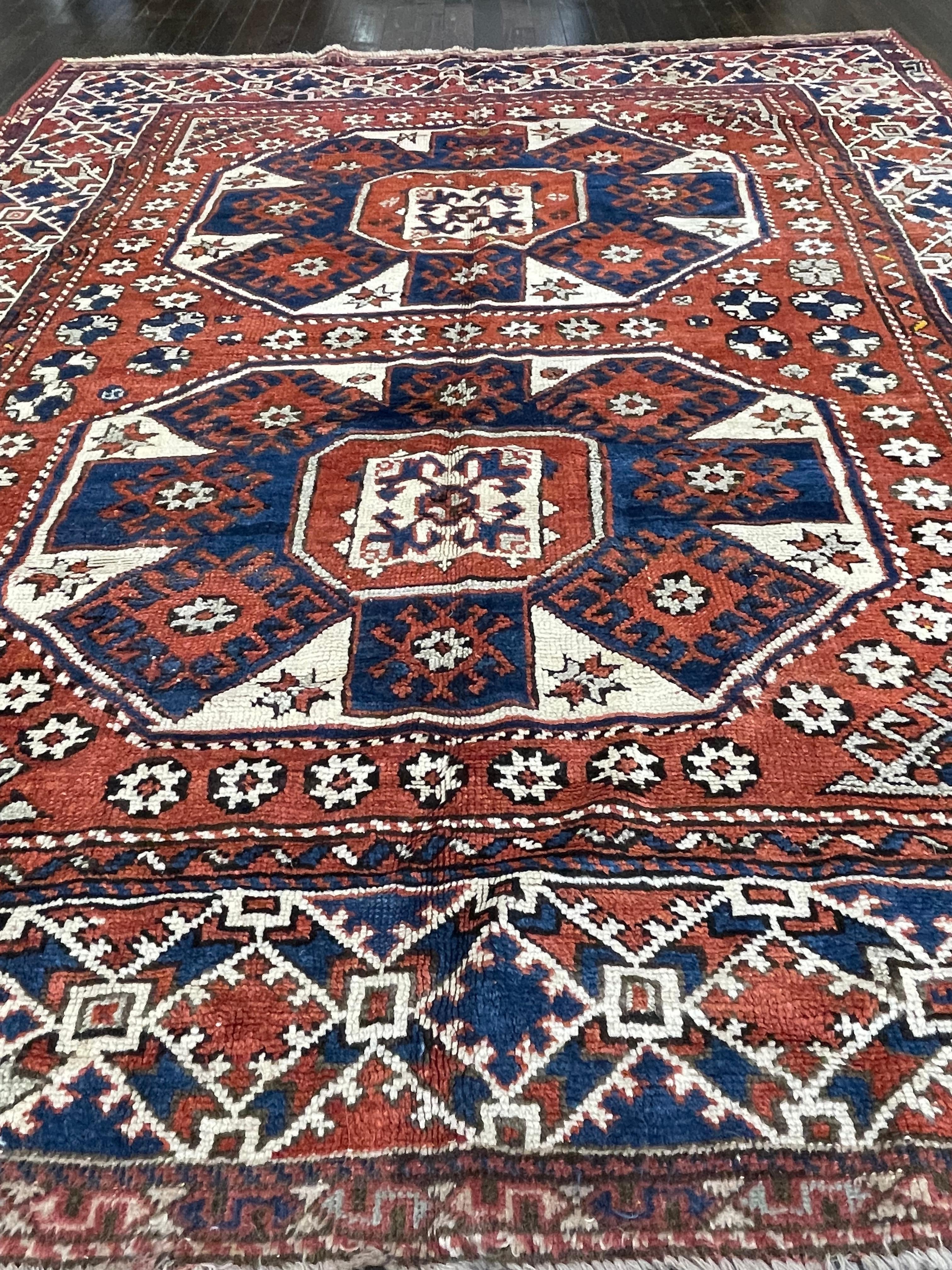 This rug is hand woven in the Caucasus mountains region. With all organic dyes and plush rich wool, this rug was woven for personal use and not to be sold in the market. The rich red and blue colors, geometric design makes this rug a signature art