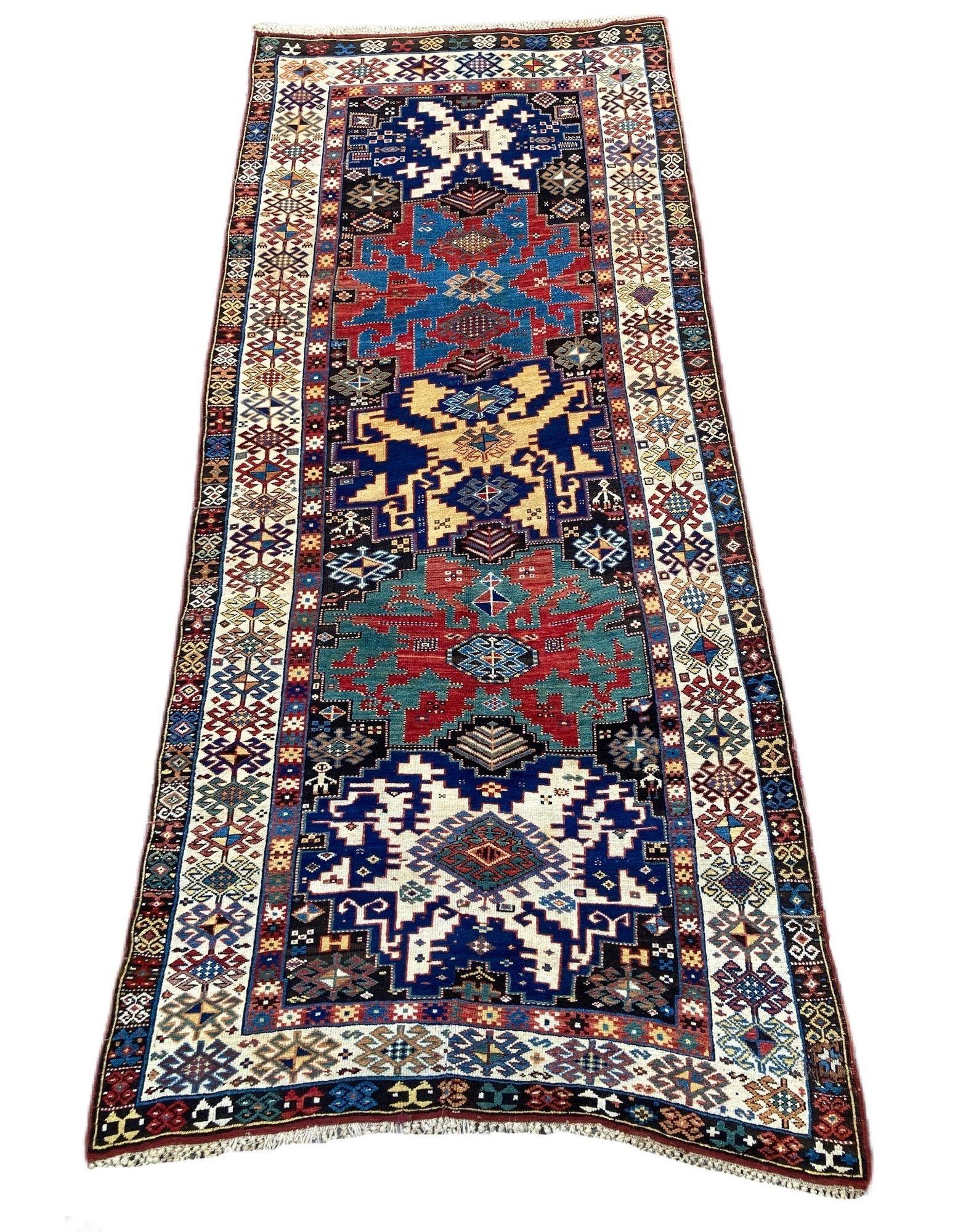 A stunning antique Kazak rug, handwoven in the Caucasus mountains of modern day Azerbaijan circa 1880. It features a 5 medallion geometrical design on a deep indigo field of stylised flowers and figures. Fabulous colours and highly
