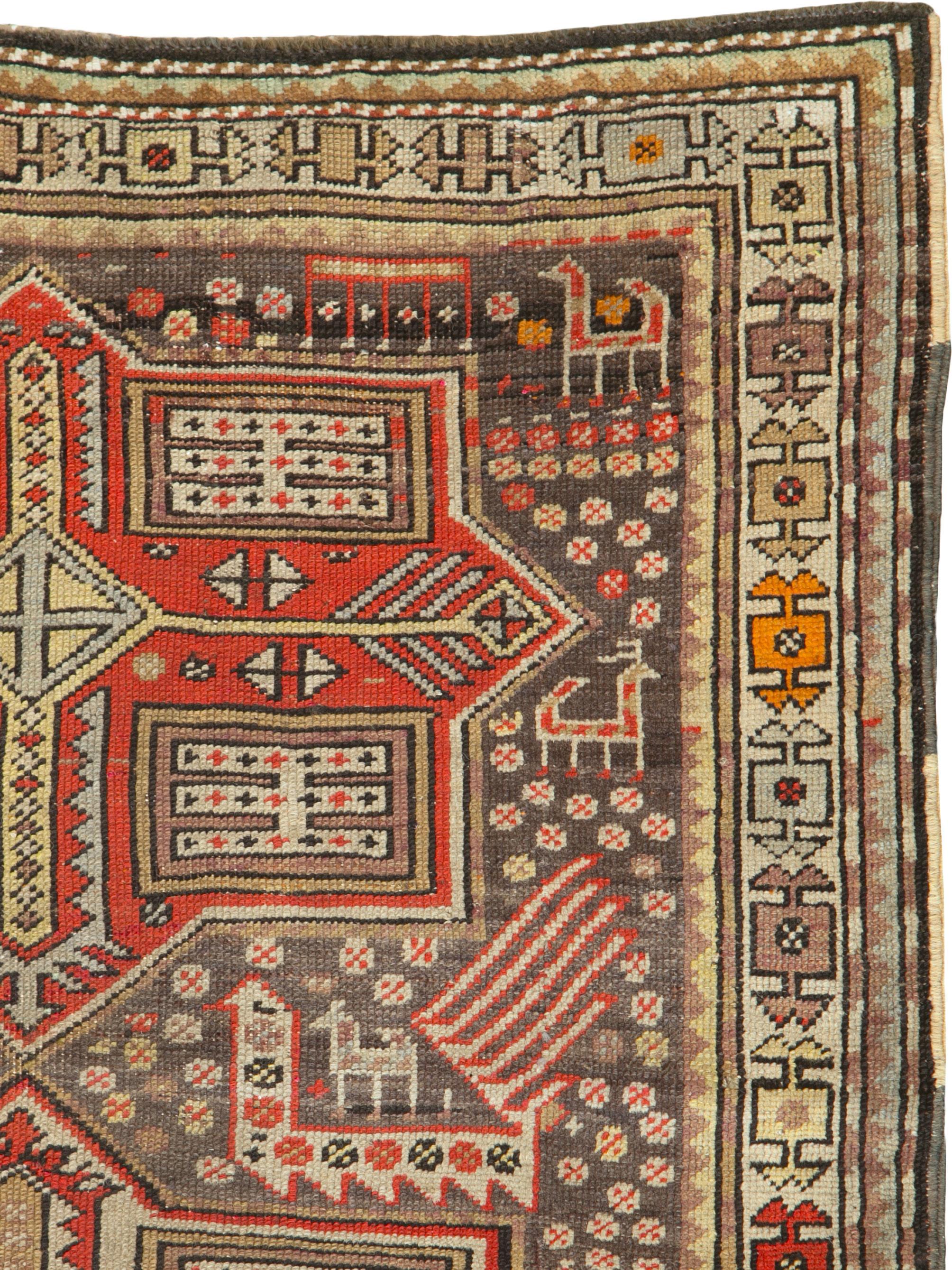 An antique Caucasian Kazak rug from the early 20th century. Three eight-point geometric medallions, 2 in red and 1 in ivory, are flanked by stylized peacocks on a grey-brown ground. Lesser animals and tiny formal devices are scattered about. The