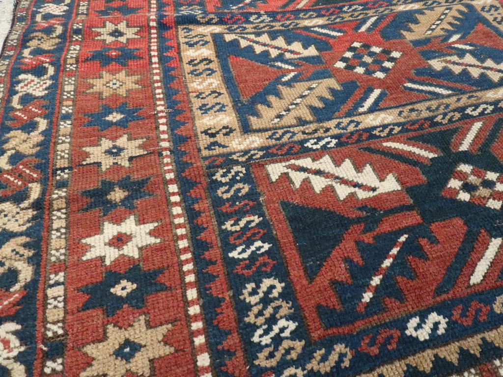 20th Century Distressed Caucasian Rug With A Tribal Design In Rust, Dark Blue, And Cream For Sale