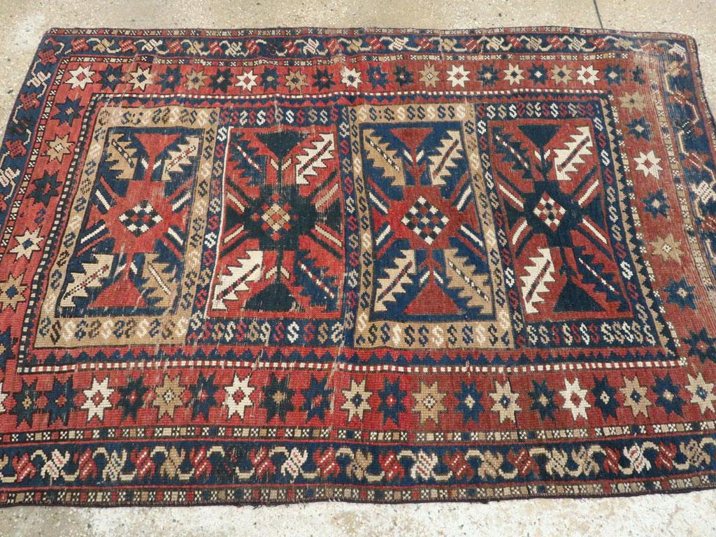 Distressed Caucasian Rug With A Tribal Design In Rust, Dark Blue, And Cream For Sale 1