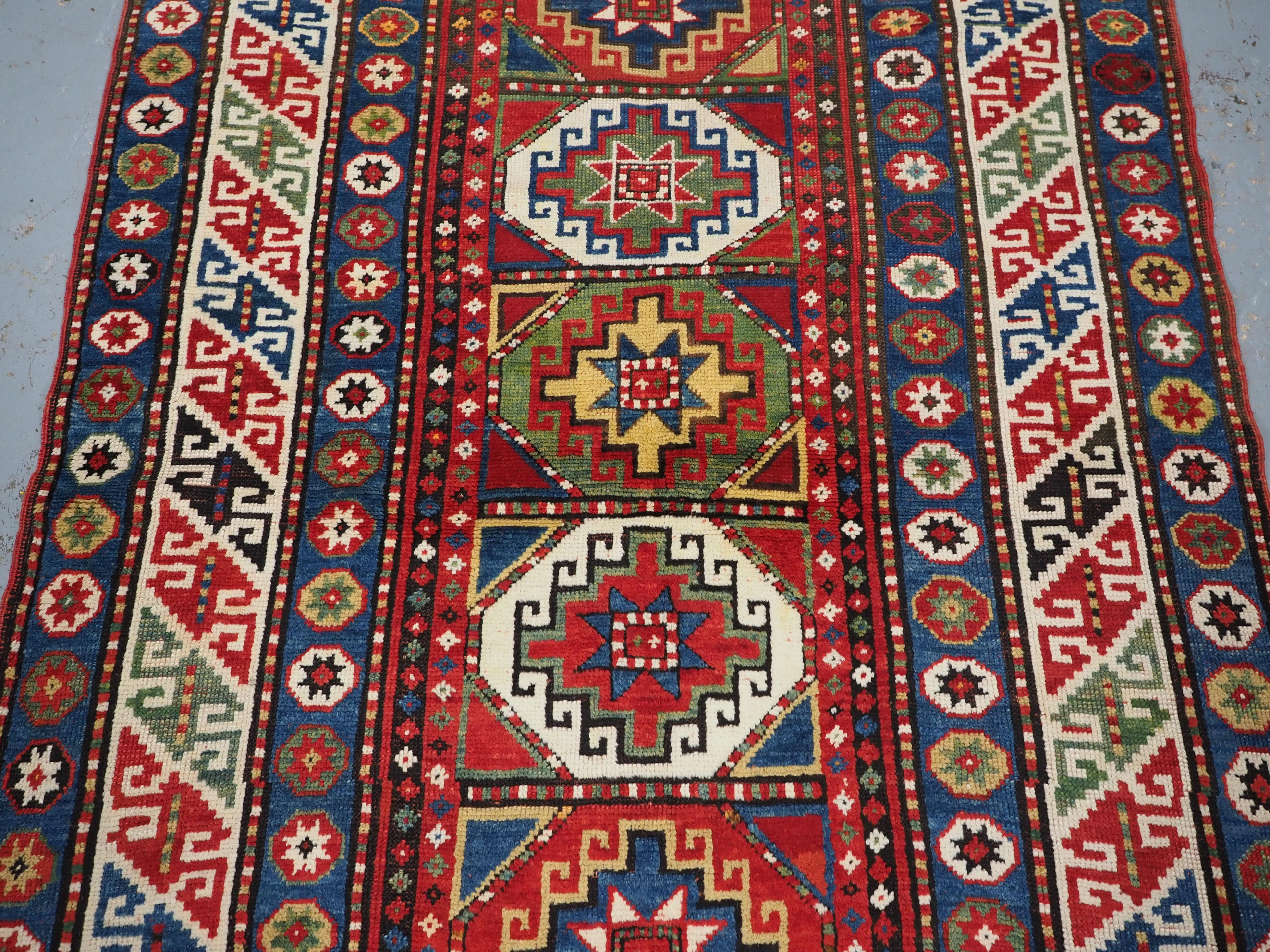 Late 19th Century Antique Caucasian Kazak rug with a single column of boxed 'Memlinc guls'. For Sale