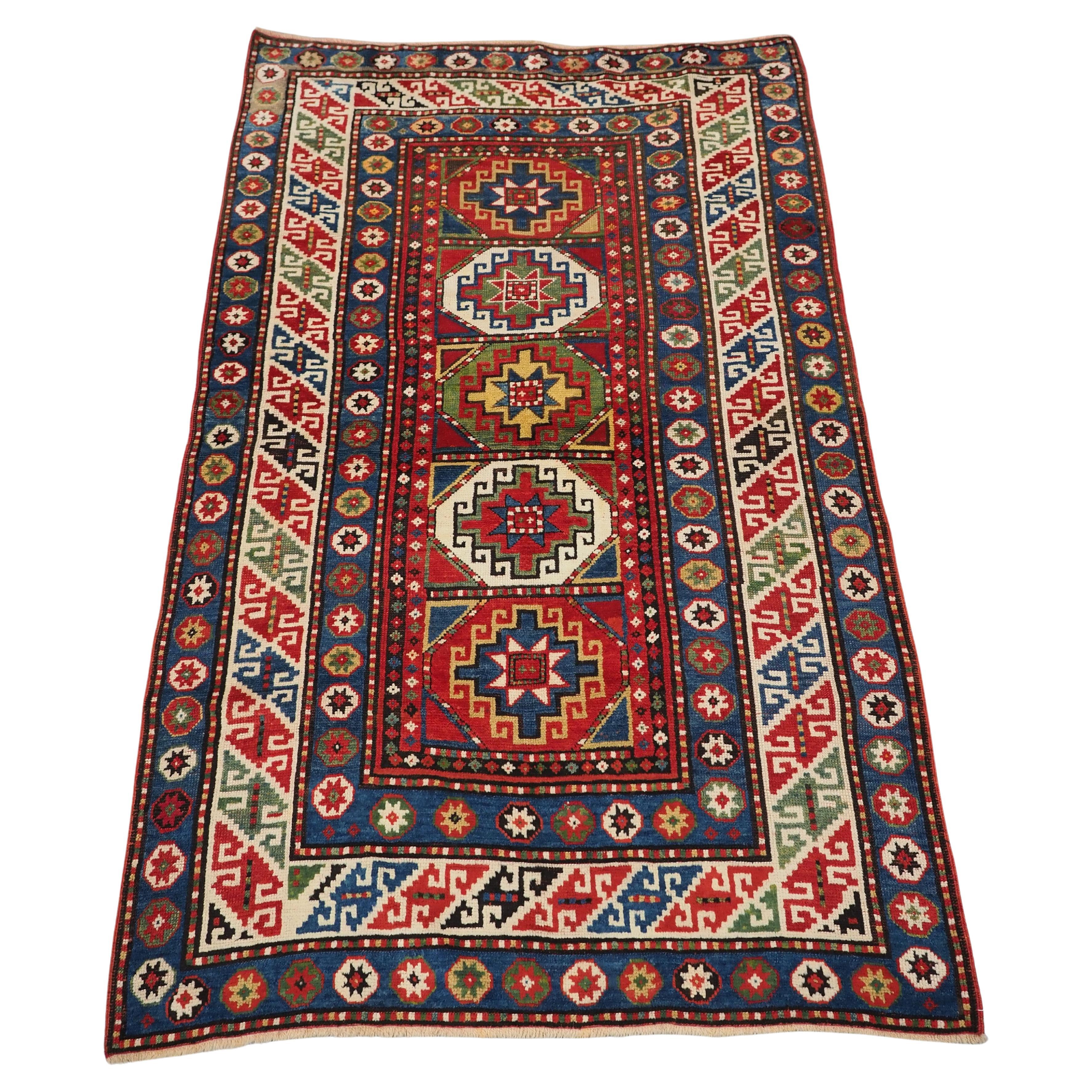 Antique Caucasian Kazak rug with a single column of boxed 'Memlinc guls'. For Sale