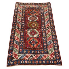 Antique Caucasian Kazak rug with a single column of boxed 'Memlinc guls'.