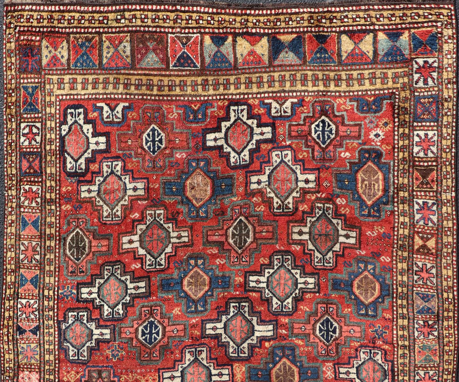 Antique Kazak Caucasian rug with all-over Tribal Design and repeating Medallions. Keivan Woven Arts / rug EMB-9673-P13565, country of origin / type: Caucasus / Kazak, circa 1900. 
Measures: 5'8 x 8'9 
This late 19th-century treasure is rendered in