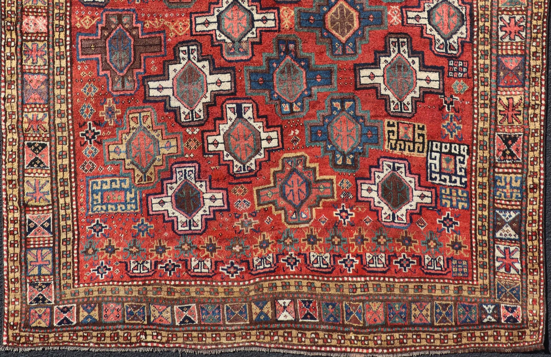 Hand-Knotted Antique Caucasian Kazak Rug with All-Over Tribal and Medallion Design For Sale