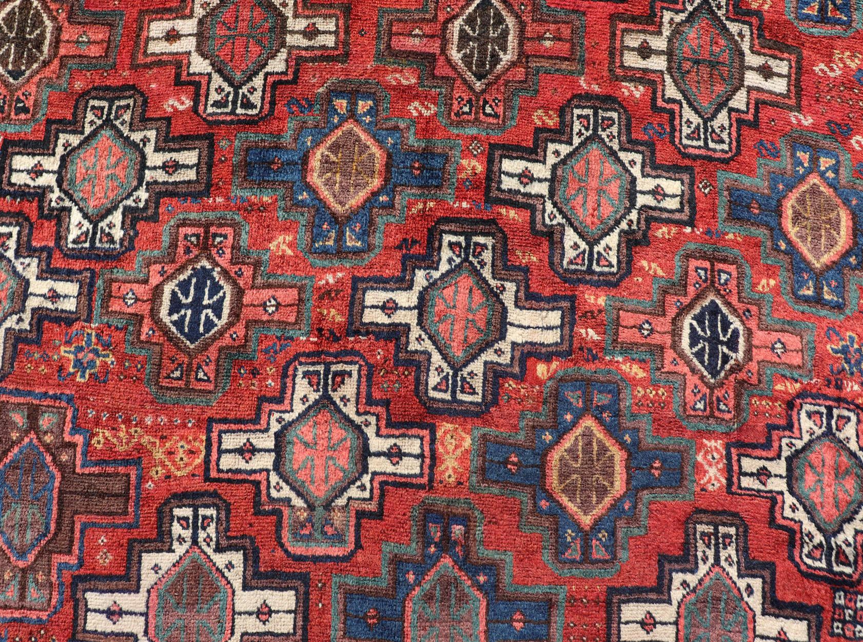 Wool Antique Caucasian Kazak Rug with All-Over Tribal and Medallion Design For Sale