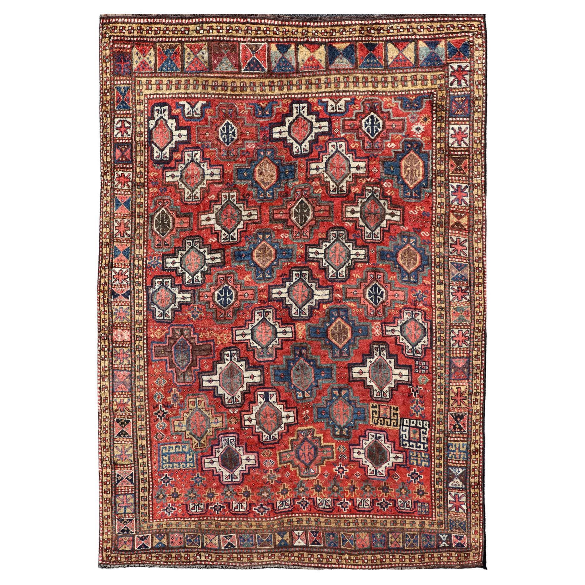 Antique Caucasian Kazak Rug with All-Over Tribal and Medallion Design For Sale