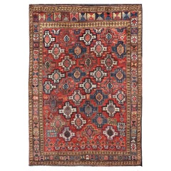 Tapis caucasien ancien de type Kazak avec motifs tribaux et médaillons sur toute sa surface