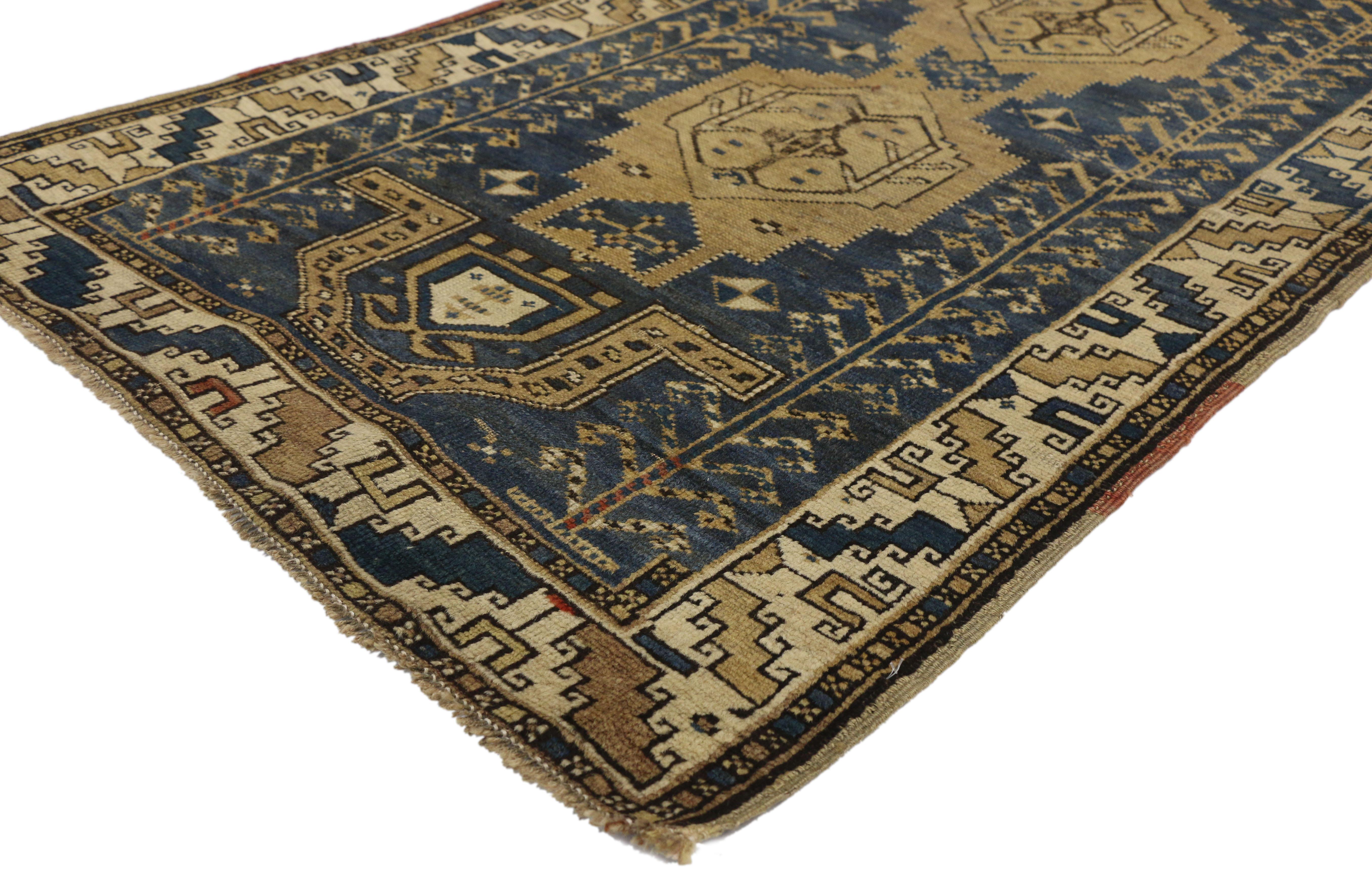 74162 Antique Caucasian Kazak rug with Artisan Tribal style. This hand knotted wool antique Caucasian Kazak rug with artisan tribal style features two medallions with a mihrab niche at either end and flanked by a vertical ram's horn pole column on