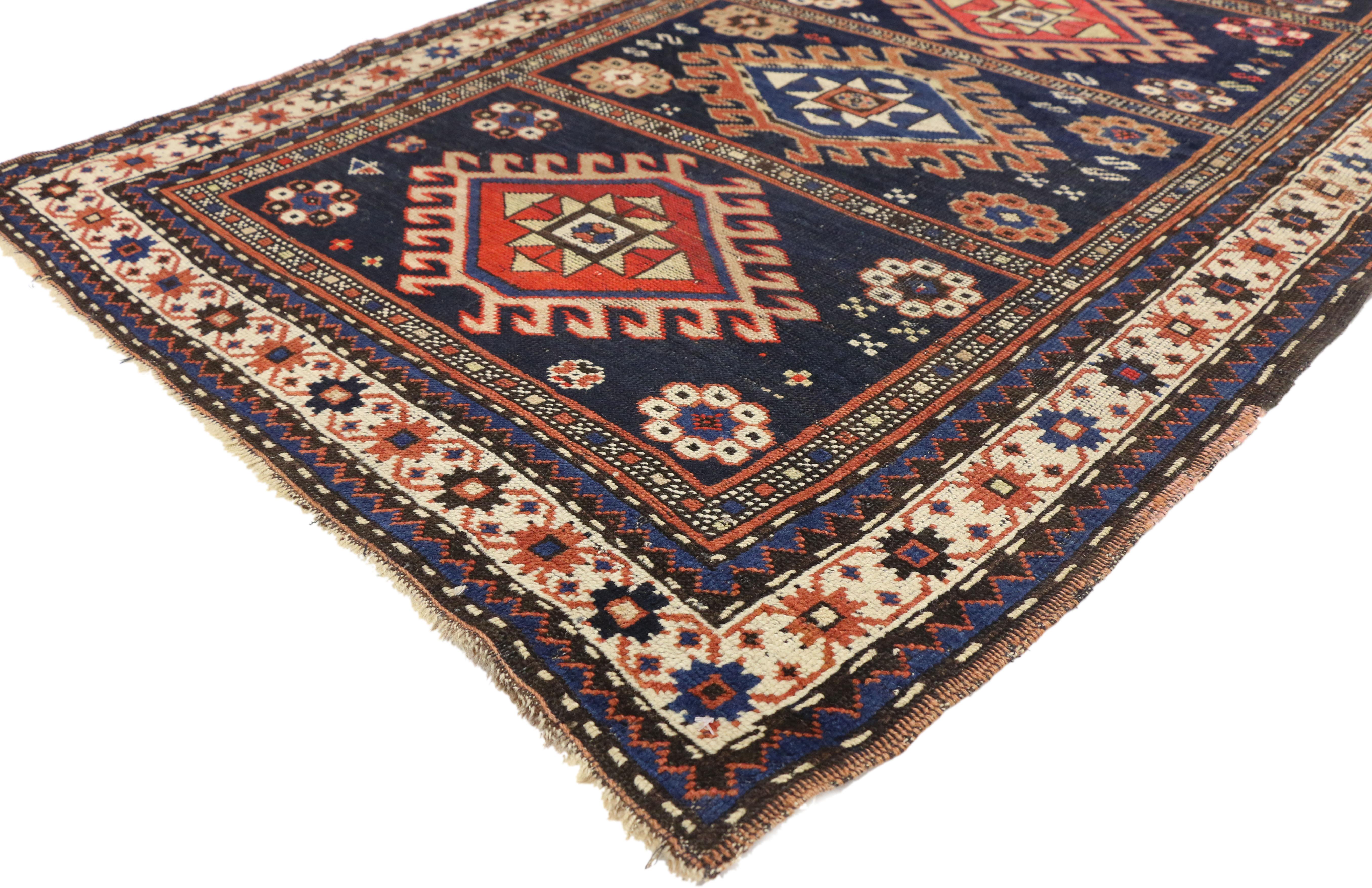 73094, antique Caucasian Kazak tribal rug with compartment design. This hand-knotted wool antique Caucasian Kazak tribal rug features a compartment design composed of four latch hook medallions. The compartments are surrounded by an s-hooks,
