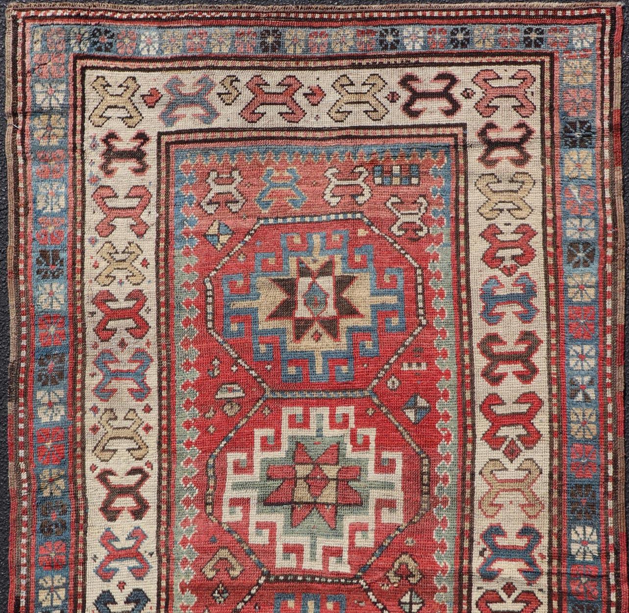 Wool Antique Caucasian Kazak Rug with Sub-Geometric Medallion's Design For Sale