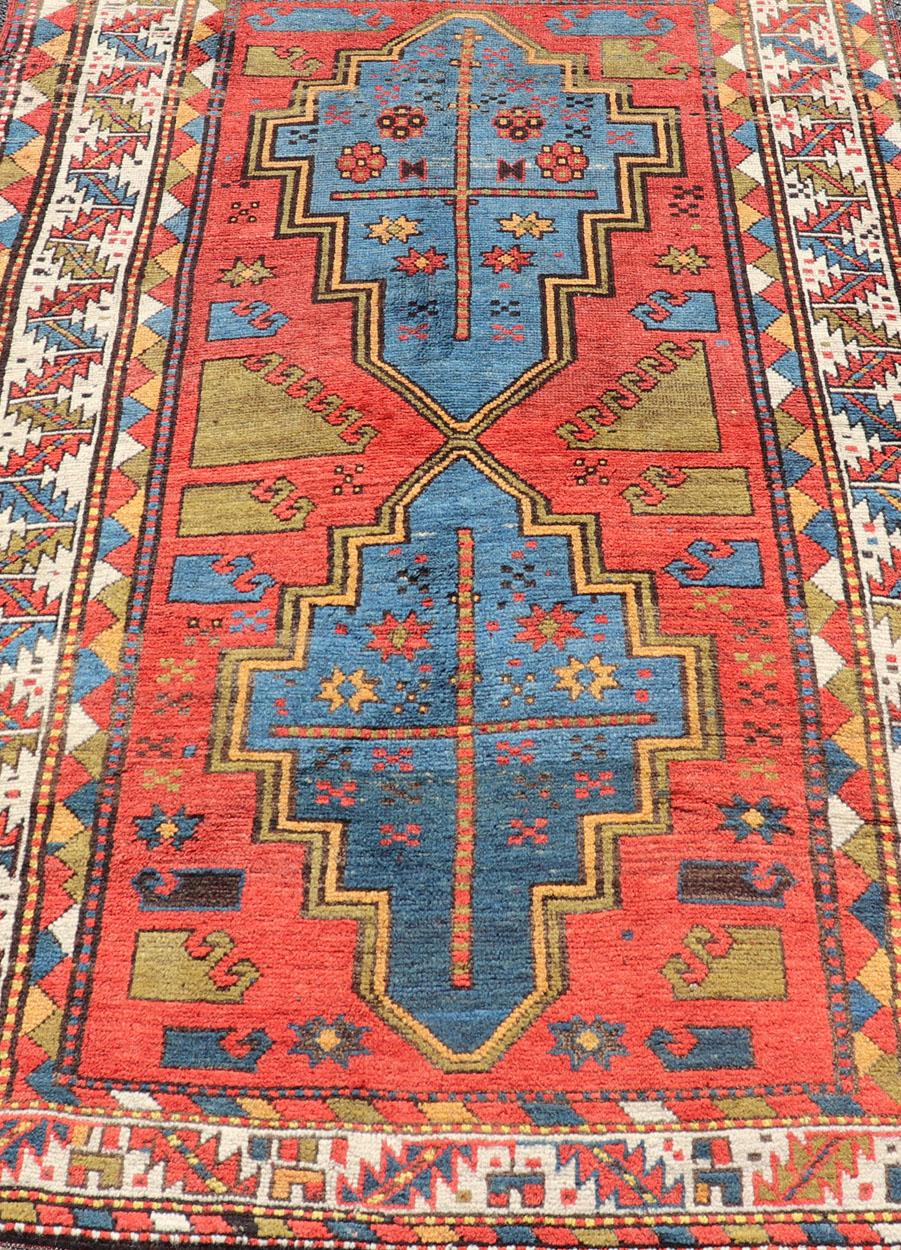 Wool Antique Caucasian Kazak Rug with Tribal Geometric Medallion in Vivid Colors