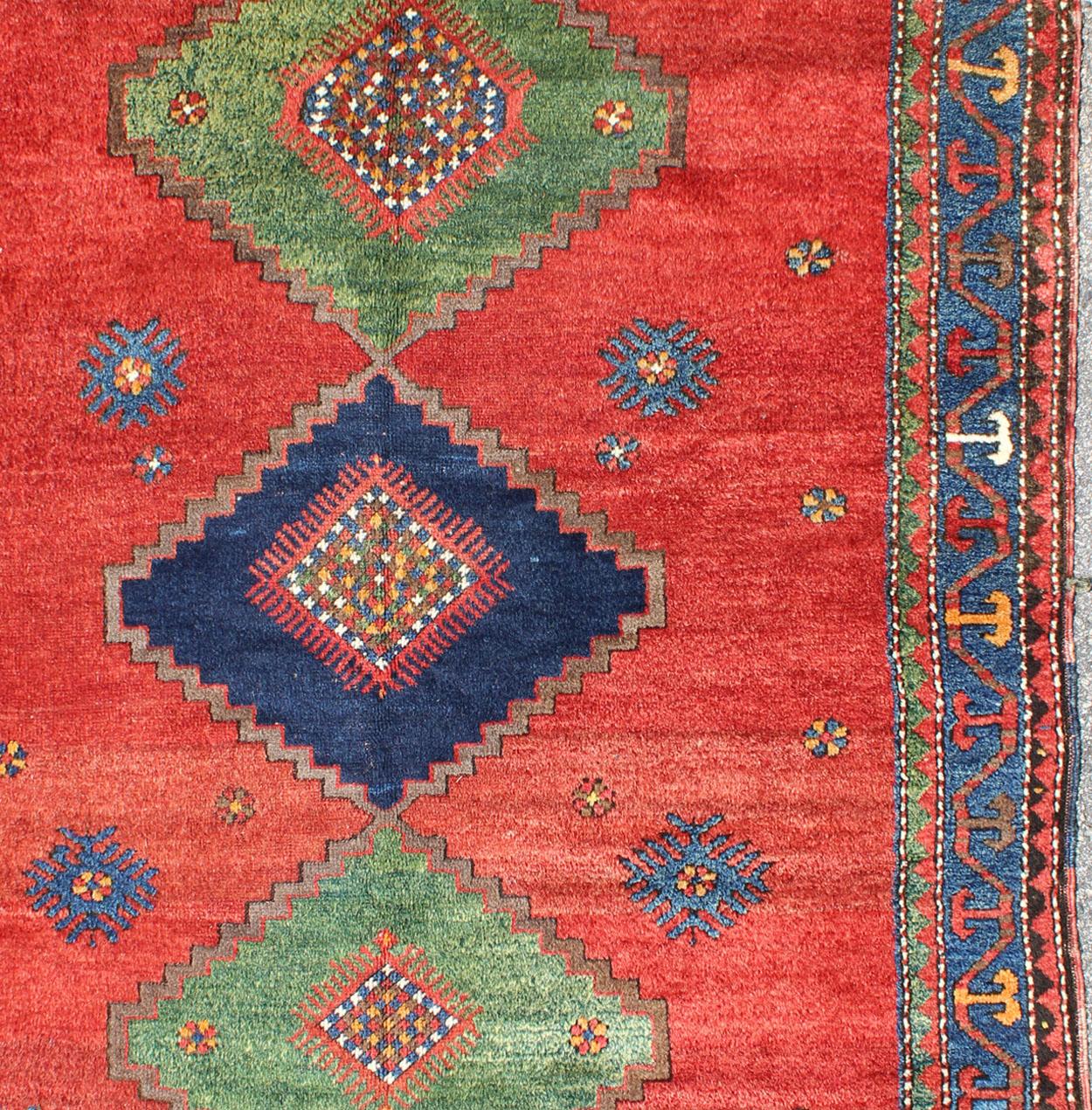 Tribal geometric medallion design Kazak rug antique from Caucasus Region in multi-colors. Keivan Woven Arts / rug 17-0910, country of origin / type: Iran / Caucasian Kazak, circa 1900.
Measures:4'8 x 6'4.
Brilliant Kazak rugs are among the most