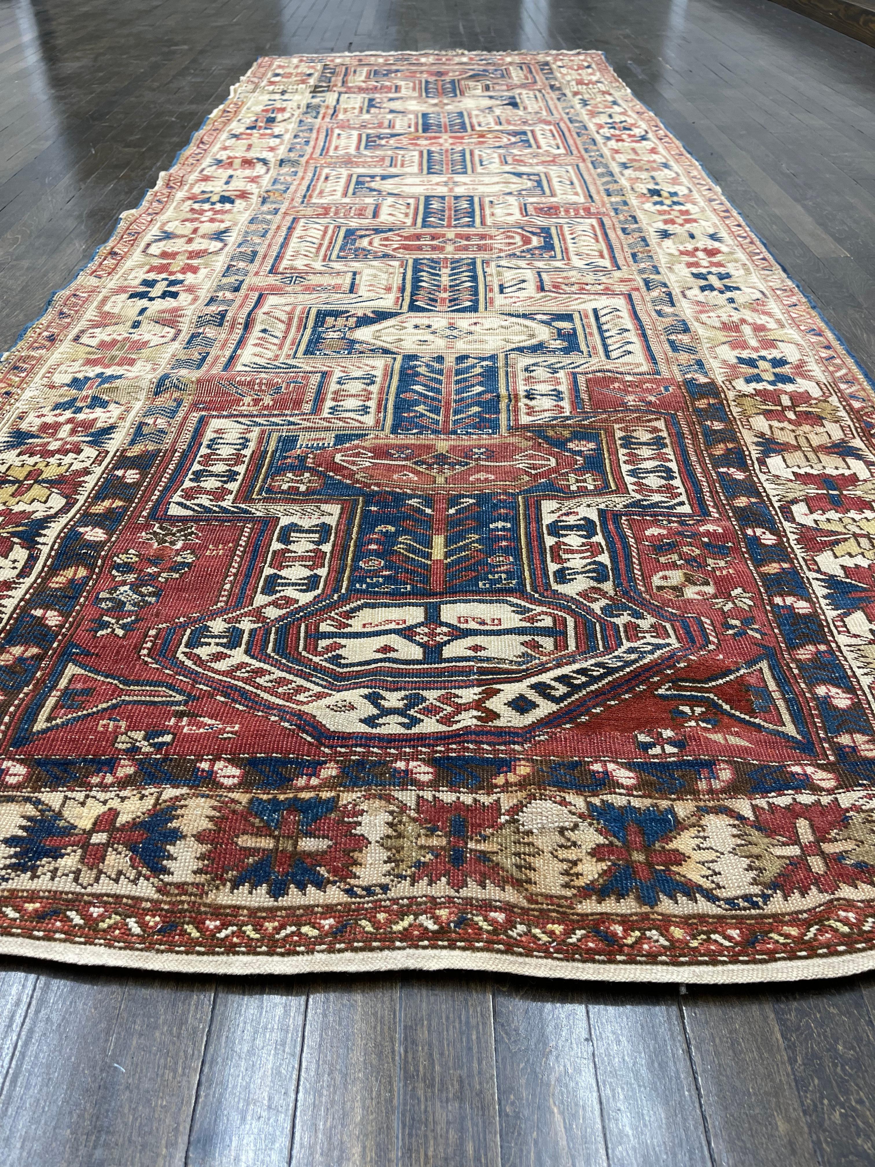 This rug is hand woven in the Caucasus in the Kazak region. The distressed condition of the rug with all organic dyes and muted colors throughout makes it a perfect compliment for any setting. The woven date in the rug(1890) is an indication that