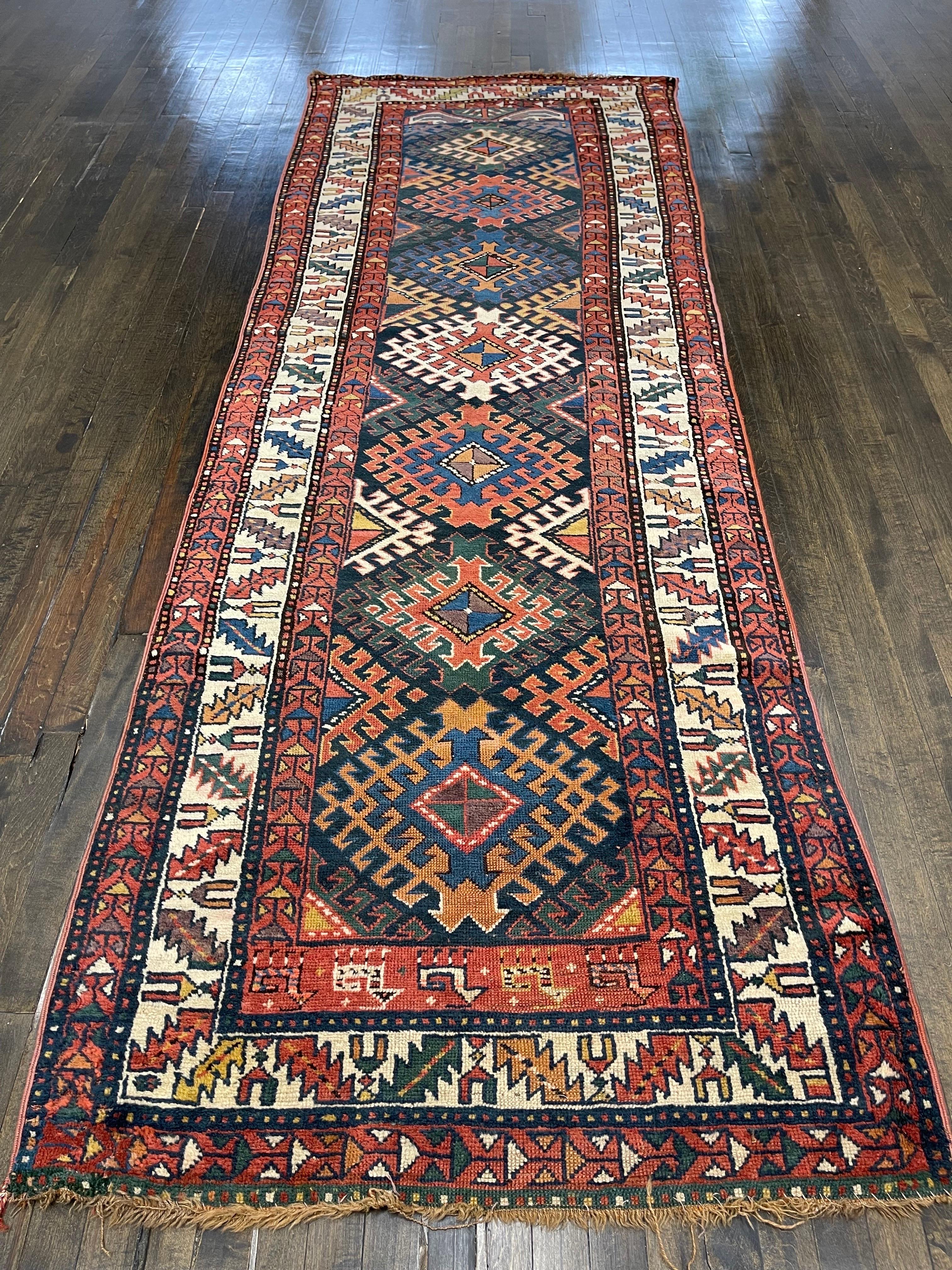 A beautiful caucasian Kazak this rug is decorated with seven solar Gul medallions with various shades of colors among them red, yellow, blue, light and dark green, apricot, lilac light and medium brown all sitting on a dark blue field. Five figures