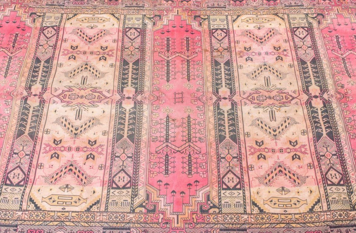 Caucasian kilim carpet in a geometric pattern in shades of rose, beige and brown.

Dealer: S138XX