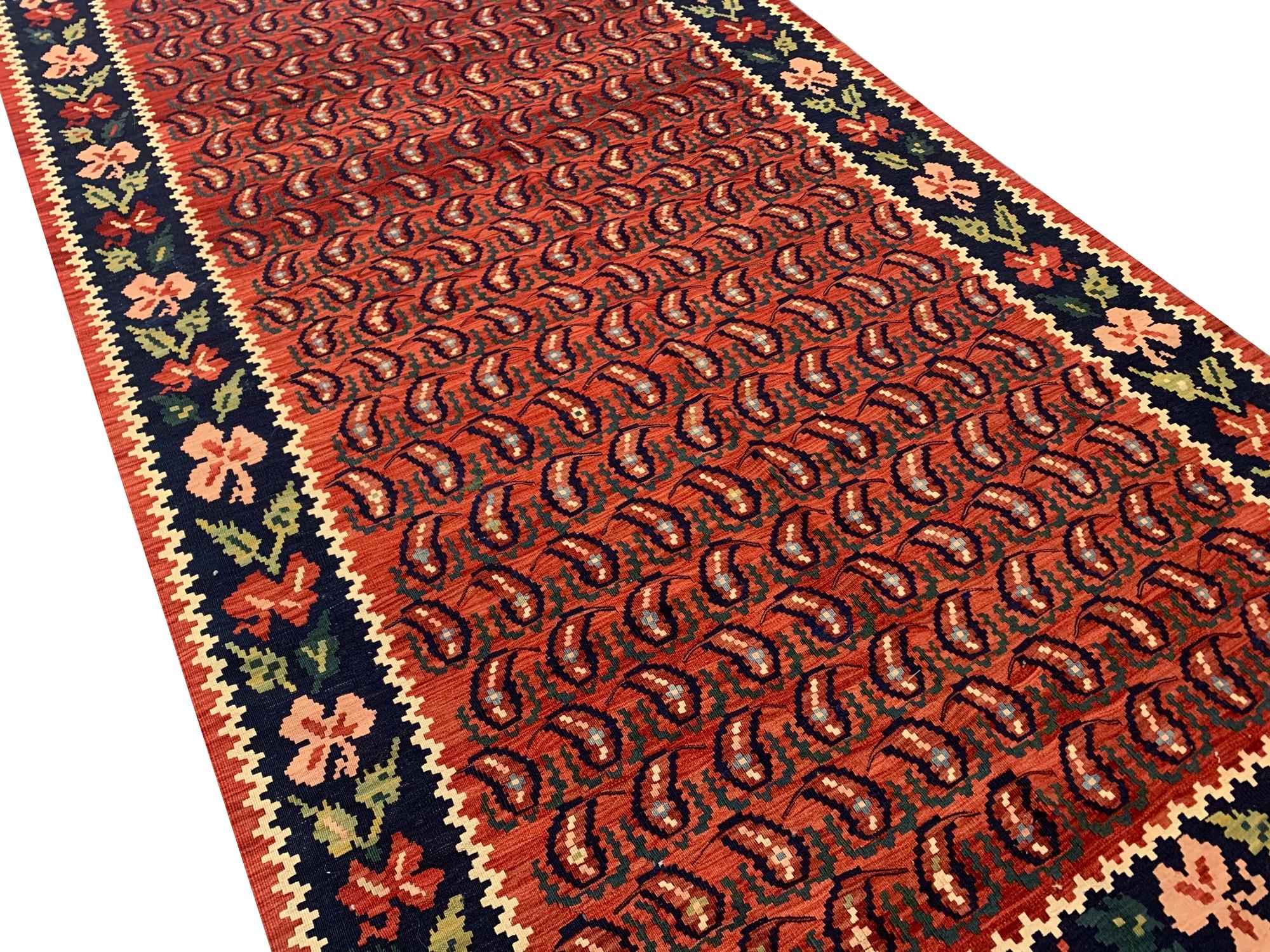 A stunning vintage Caucasia kilim that seamlessly blends traditional design elements with captivating motifs. Adorned with a central medallion surrounded by intricate patterns and a charming repeating border, this rug embodies the rich heritage of