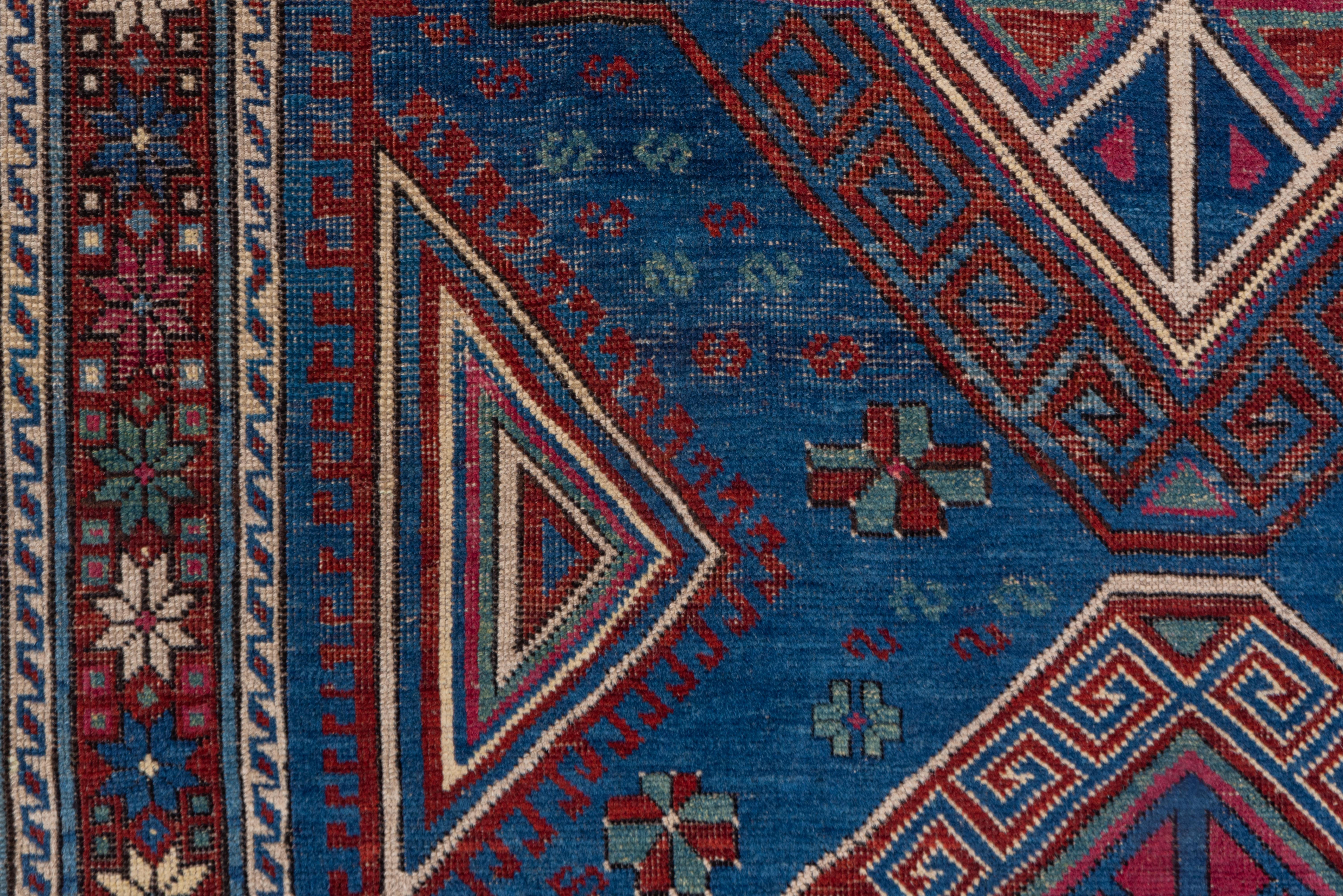 Antique Caucasian Kuba Area Rug, Dark Blue Field, Red Borders, Pink Accents In Good Condition For Sale In New York, NY