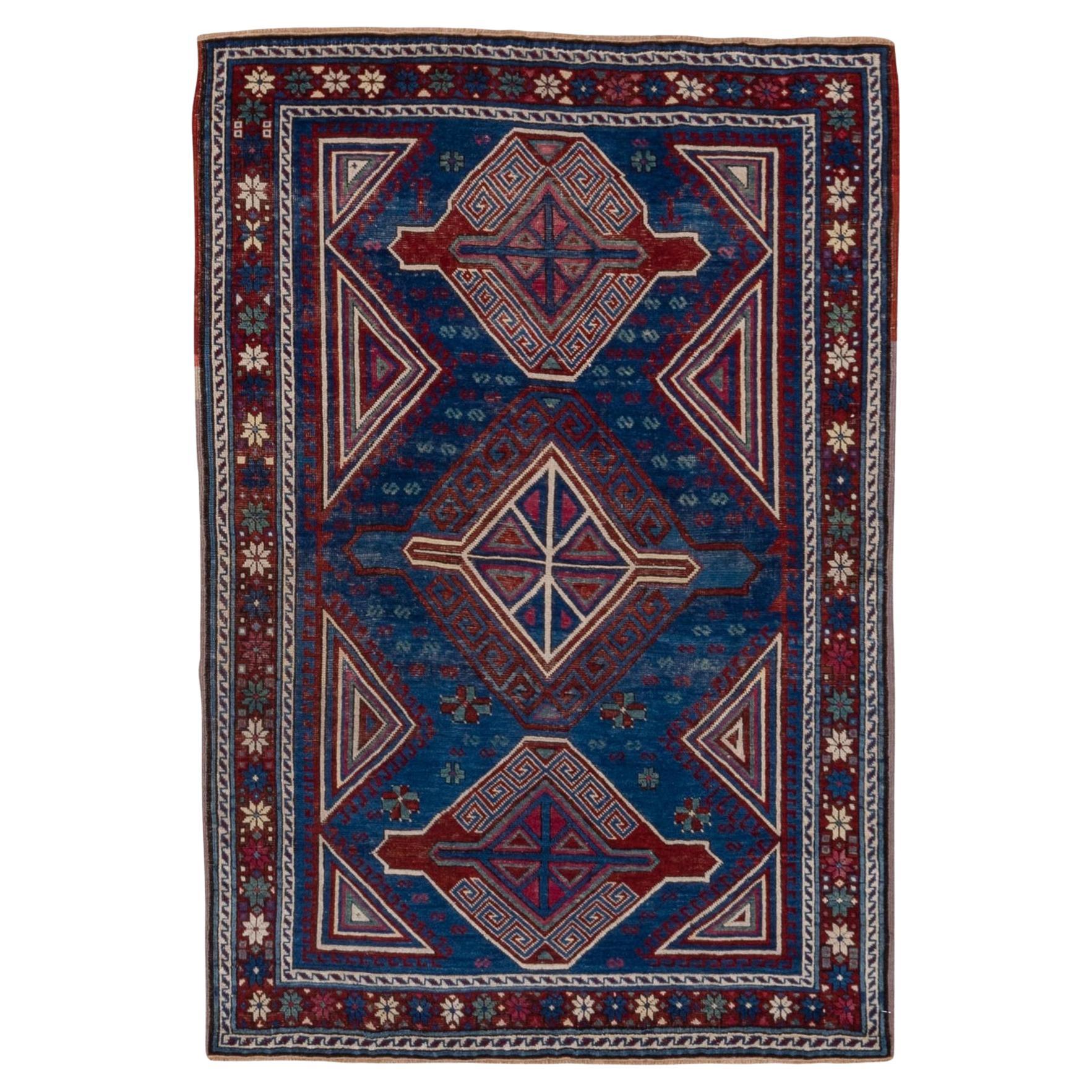 Antique Caucasian Kuba Area Rug, Dark Blue Field, Red Borders, Pink Accents For Sale