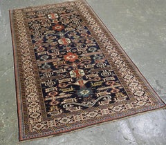 Antique Caucasian Kuba region Perepedil rug with an indigo blue ground.