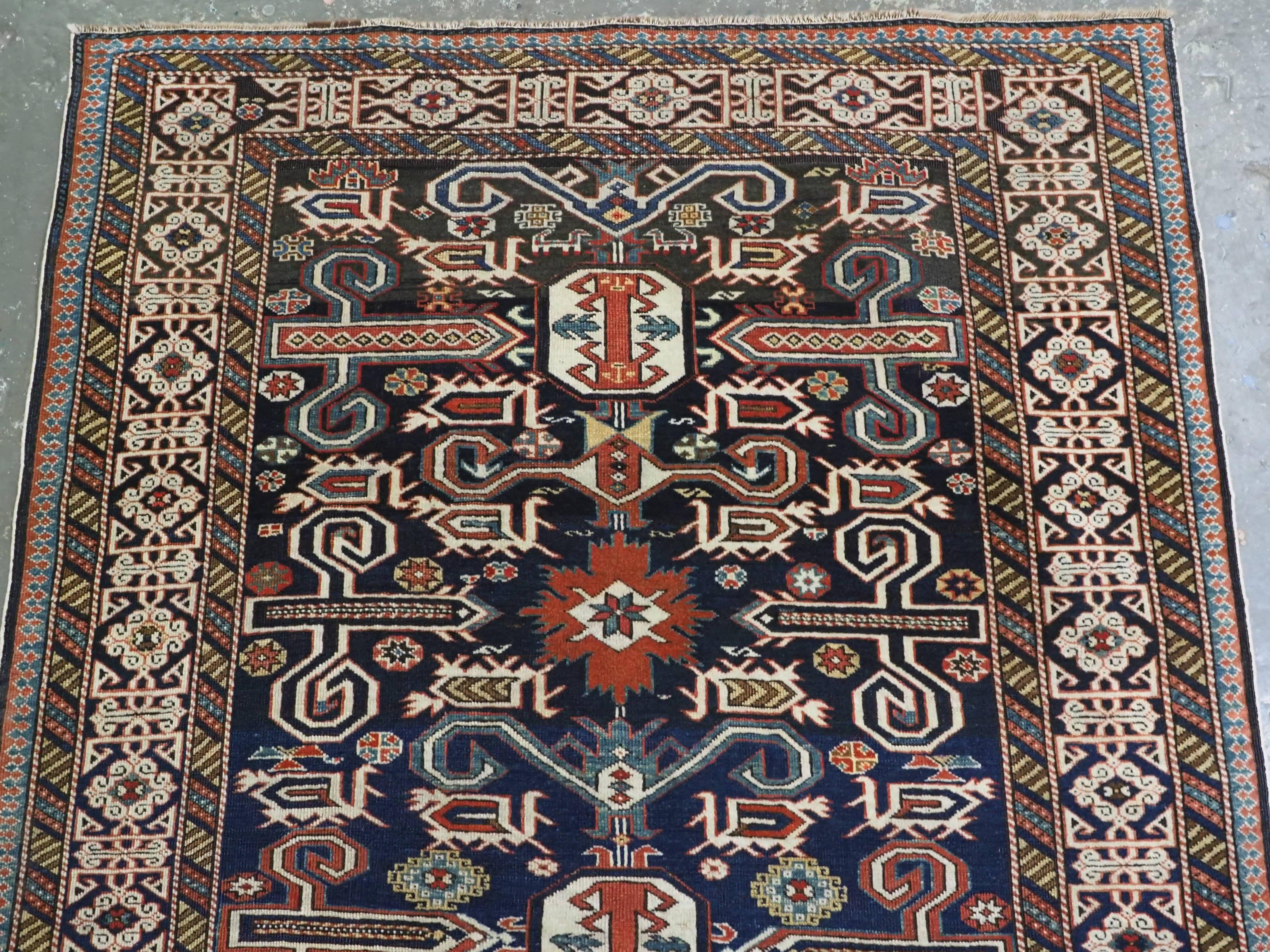 Antique Caucasian Kuba region Perepedil rug with an indigo blue ground. In Good Condition For Sale In Moreton-In-Marsh, GB