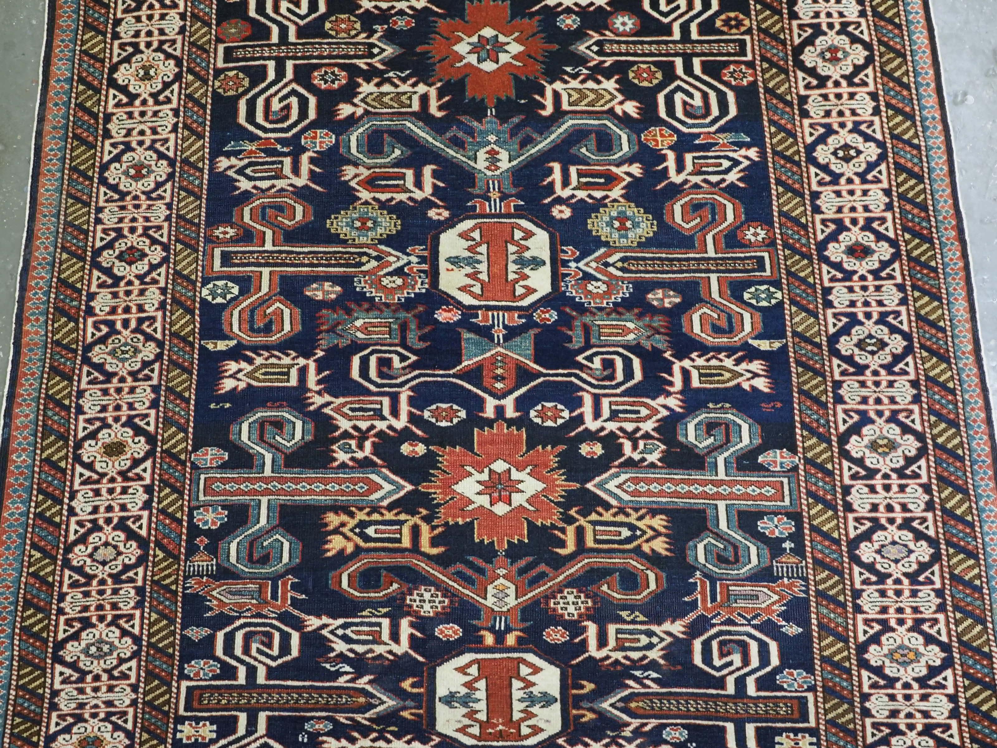Late 19th Century Antique Caucasian Kuba region Perepedil rug with an indigo blue ground. For Sale