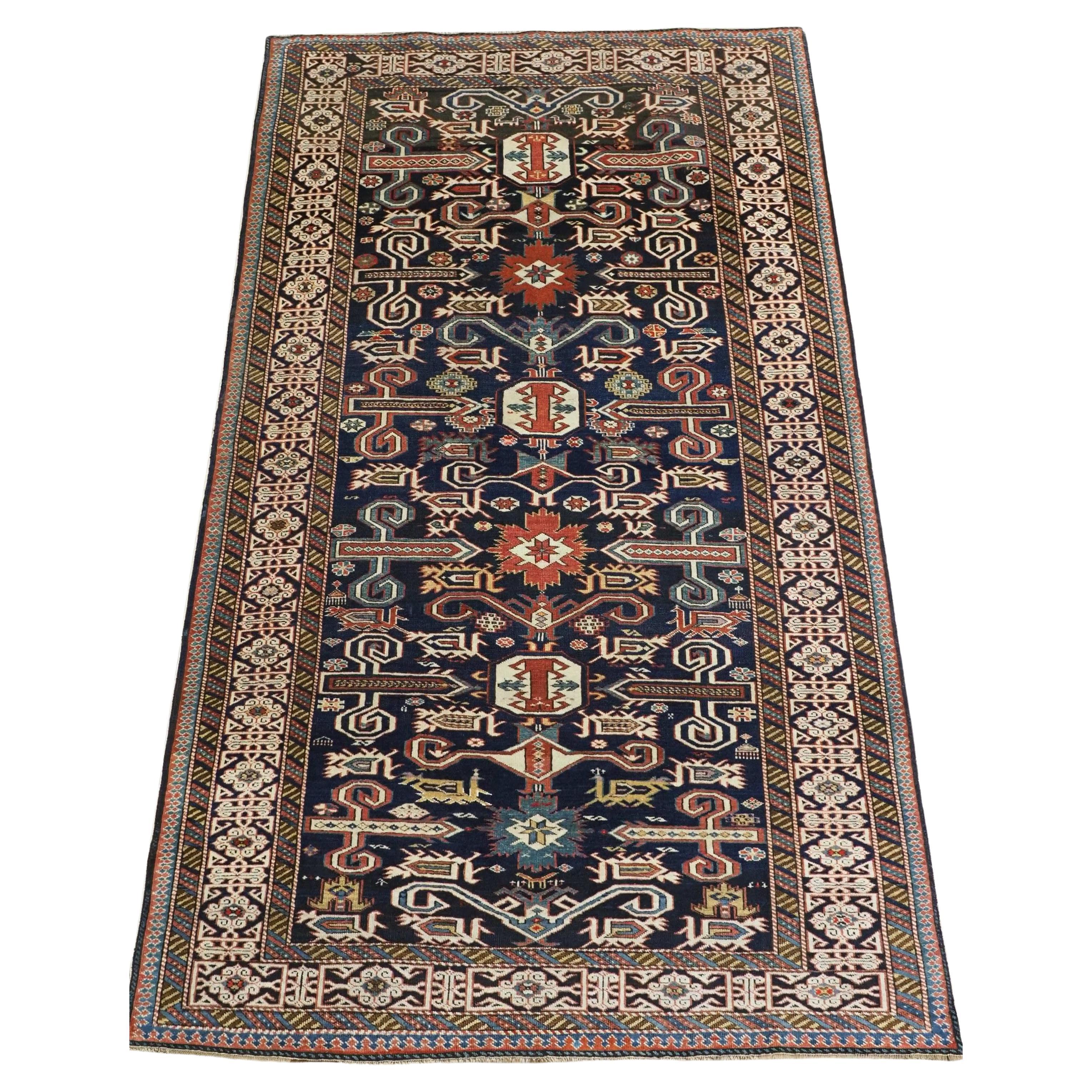 Antique Caucasian Kuba region Perepedil rug with an indigo blue ground.