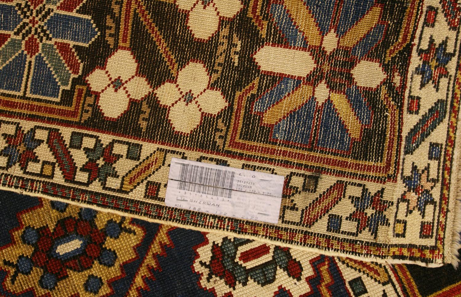 Il s'agit d'un ancien tapis Shirvan tissé dans les montagnes du Caucase à la fin du 19e siècle, vers 1880-1900. Il mesure 182 x 122 cm. Son champ est composé d'un motif de treillis à grande échelle avec des rangées alternées de médaillons et de
