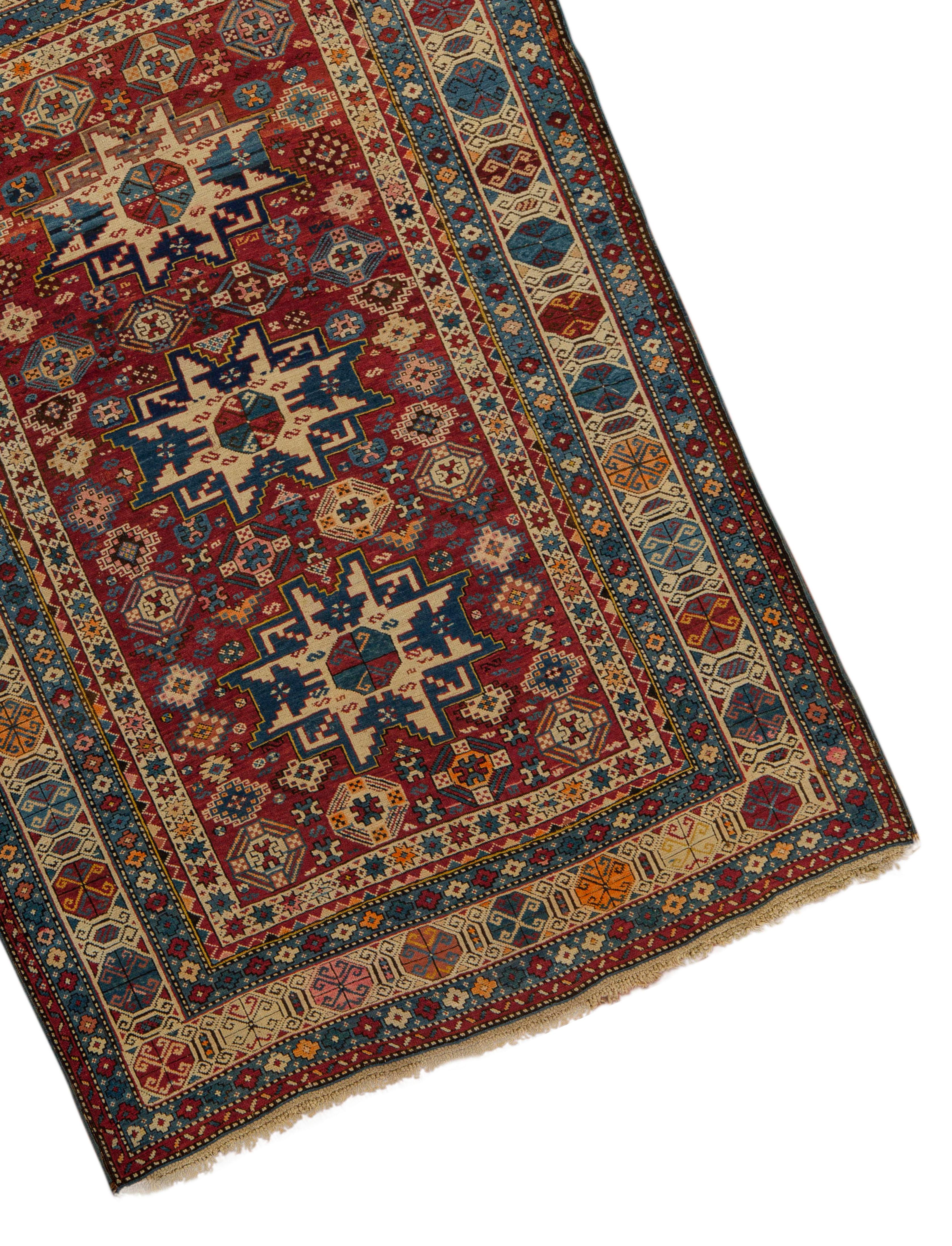 Antique Caucasian Lesghi Star rug, circa 1880, the central field with three Lesghi star motifs surrounded by ethnic symbols and designs completed by multiple borders that set the frame for the central design in a very picturesque way. Size: 3'10 x