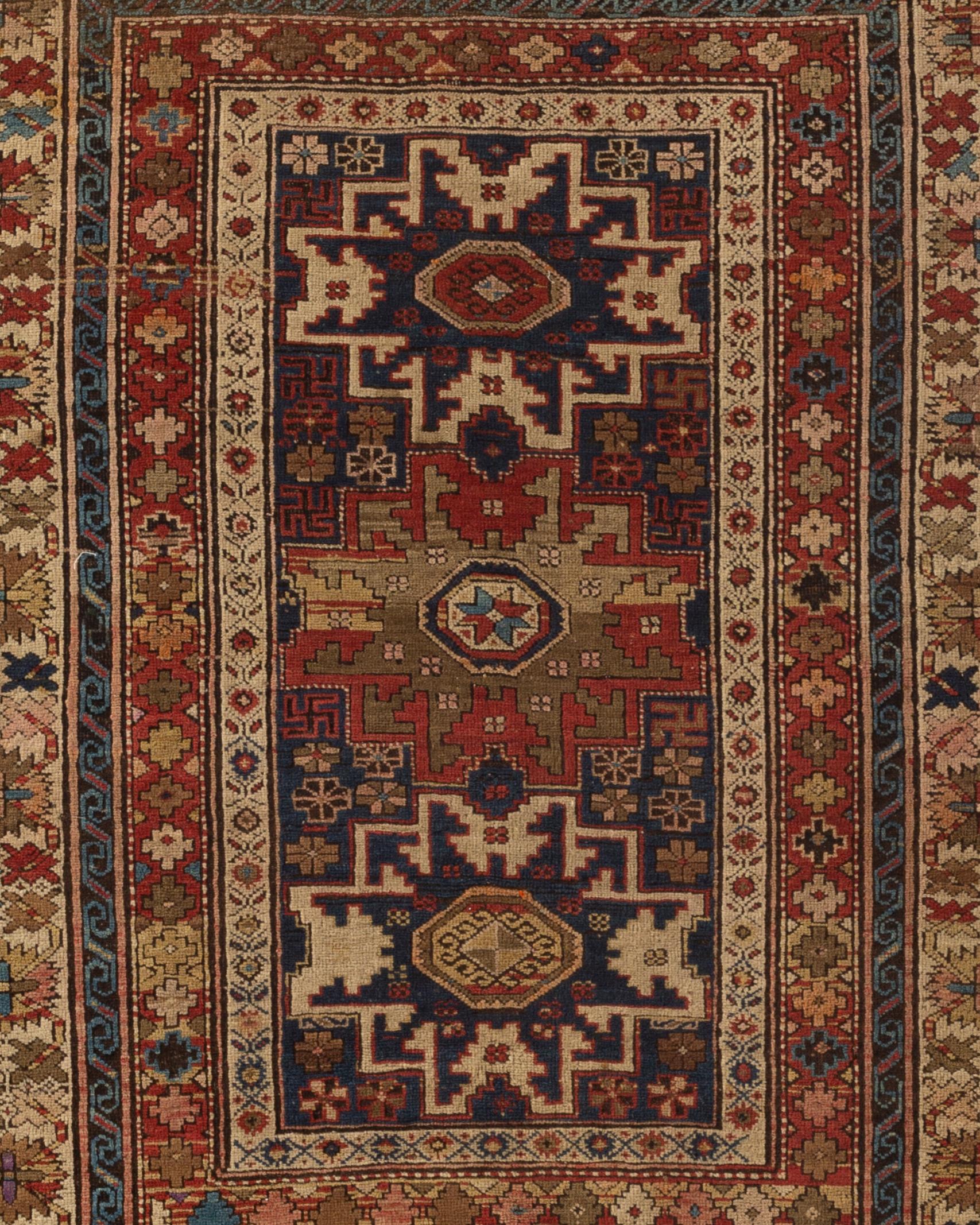 Antique Caucasian Lesghi Star rug, circa 1880, the central field with the two distinctive star motifs that are the signature element in rugs from this area surrounded by ethnic symbols and designs completed by multiple borders that set the frame for