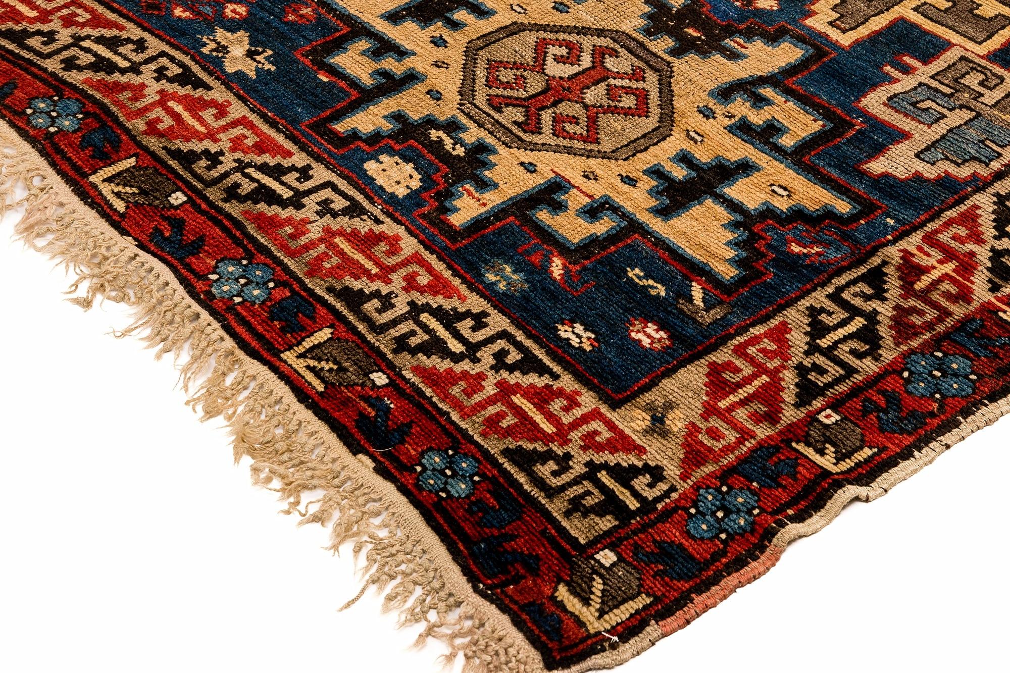 The iconic “Lesghi Star” motif is stunning on this antique handwoven Caucasus rug, woven in the Southern Kuba region of Azerbaijan. The vivid complimentary colors and design created by the weaver makes for a very well thought out artistic