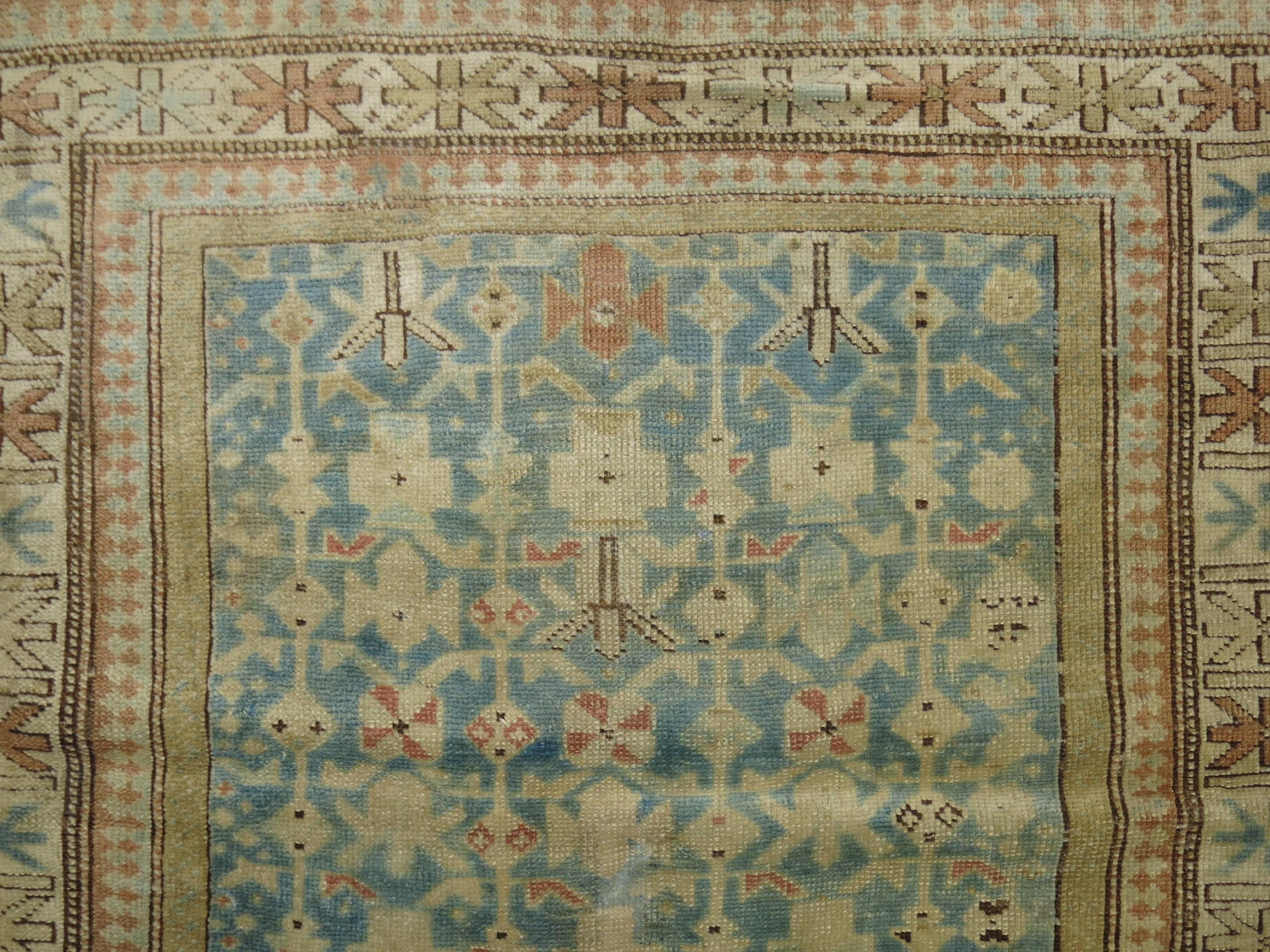 Decorative light blue colored early 20th century handmade Kuba rug in easy-going earthy palette.