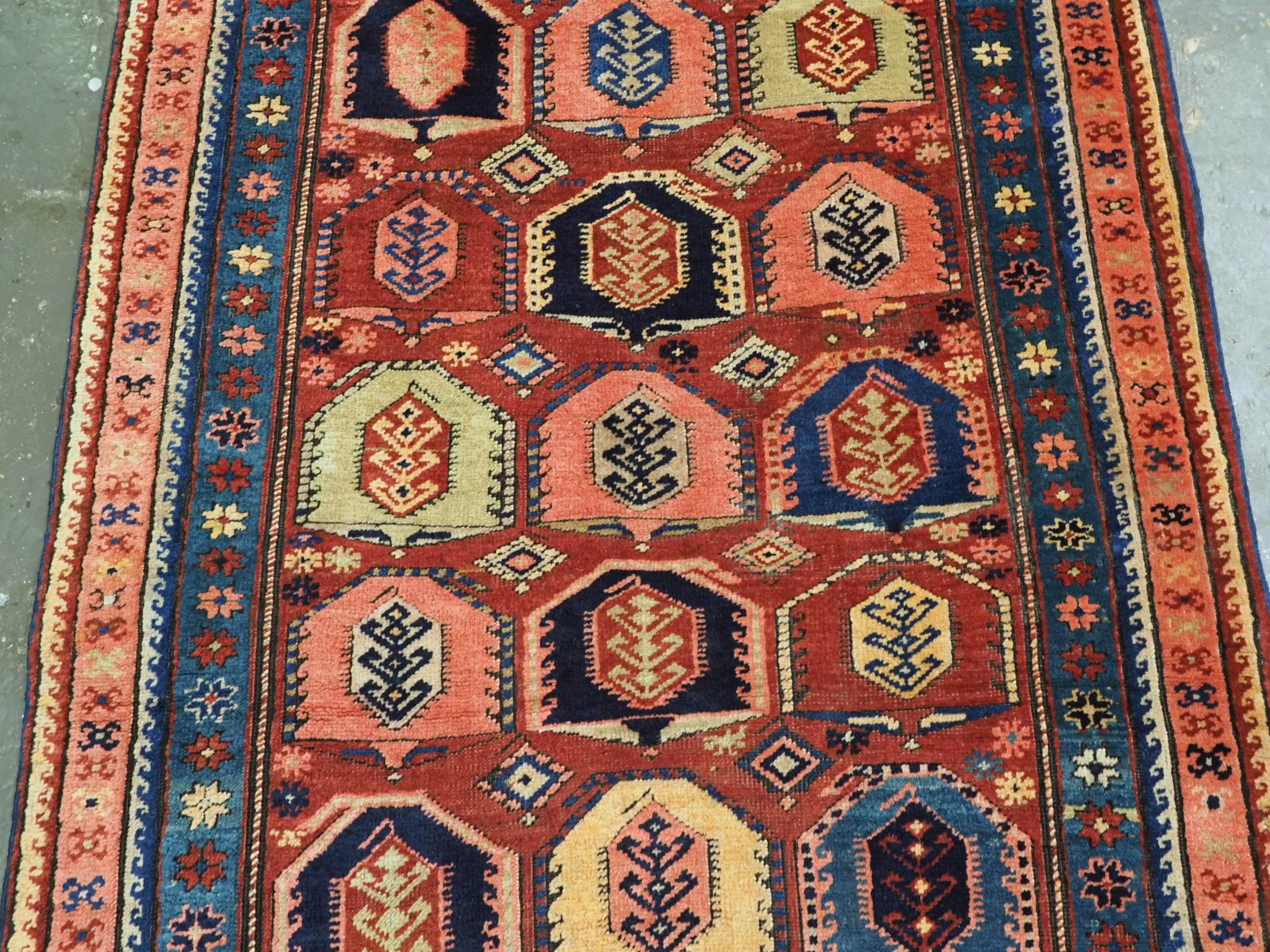 Early 20th Century Antique Caucasian long rug with all over boteh design.  Circa 1900. For Sale