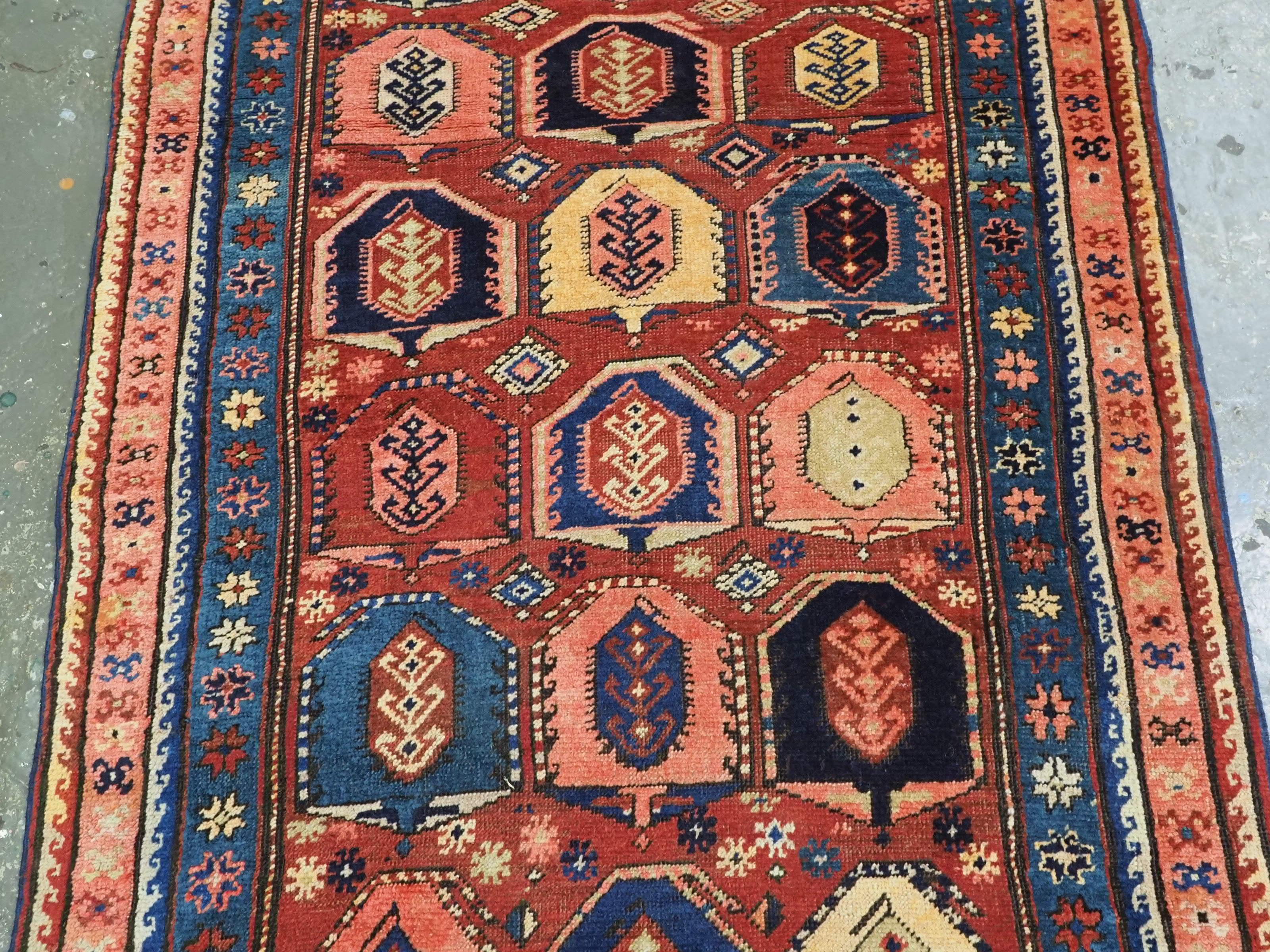 Wool Antique Caucasian long rug with all over boteh design.  Circa 1900. For Sale