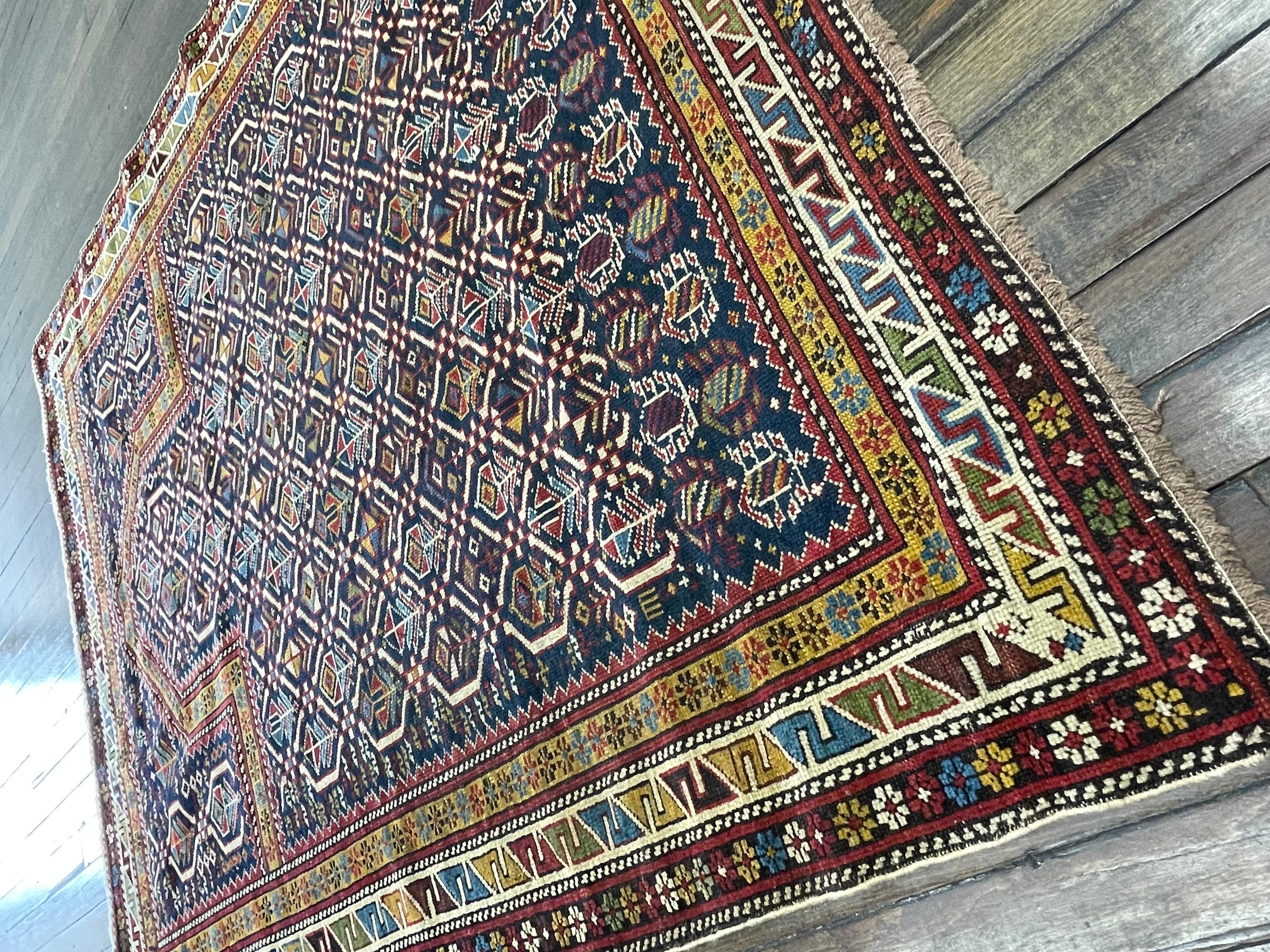This amazing caucasion rug,known as Marsali was handwoven in the Shirvan region of the Caucasus mountains.The rich indigo blue(indigo is a tropical plant in pea family) field with brilliant red,yellow and light blue border light brown guard framing