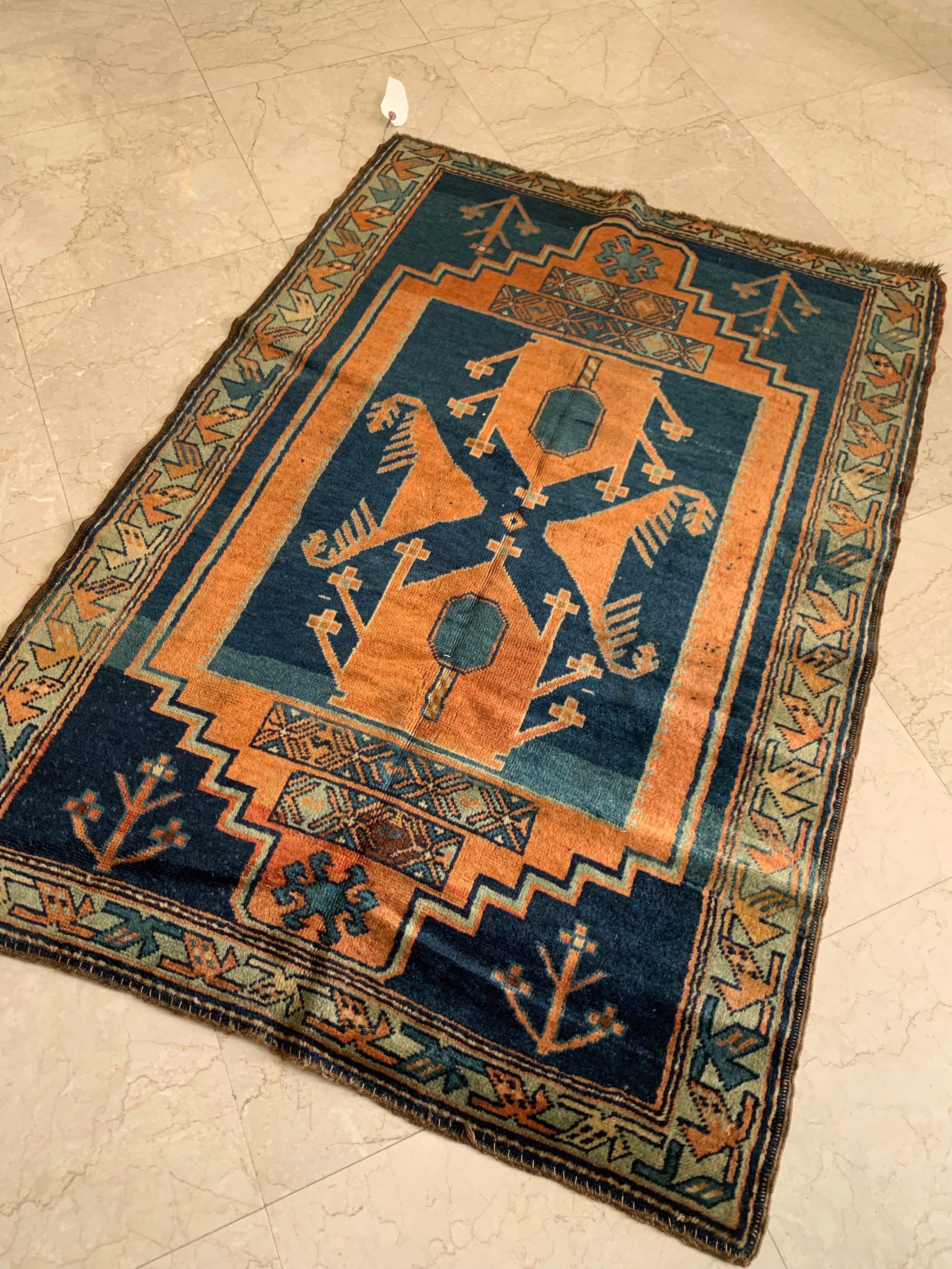 This is a lovely antique Caucasian orange and blue brown Kazak Tribal Geometric rug circa 1920-1930 measuring 3.2 x 4.5 ft.