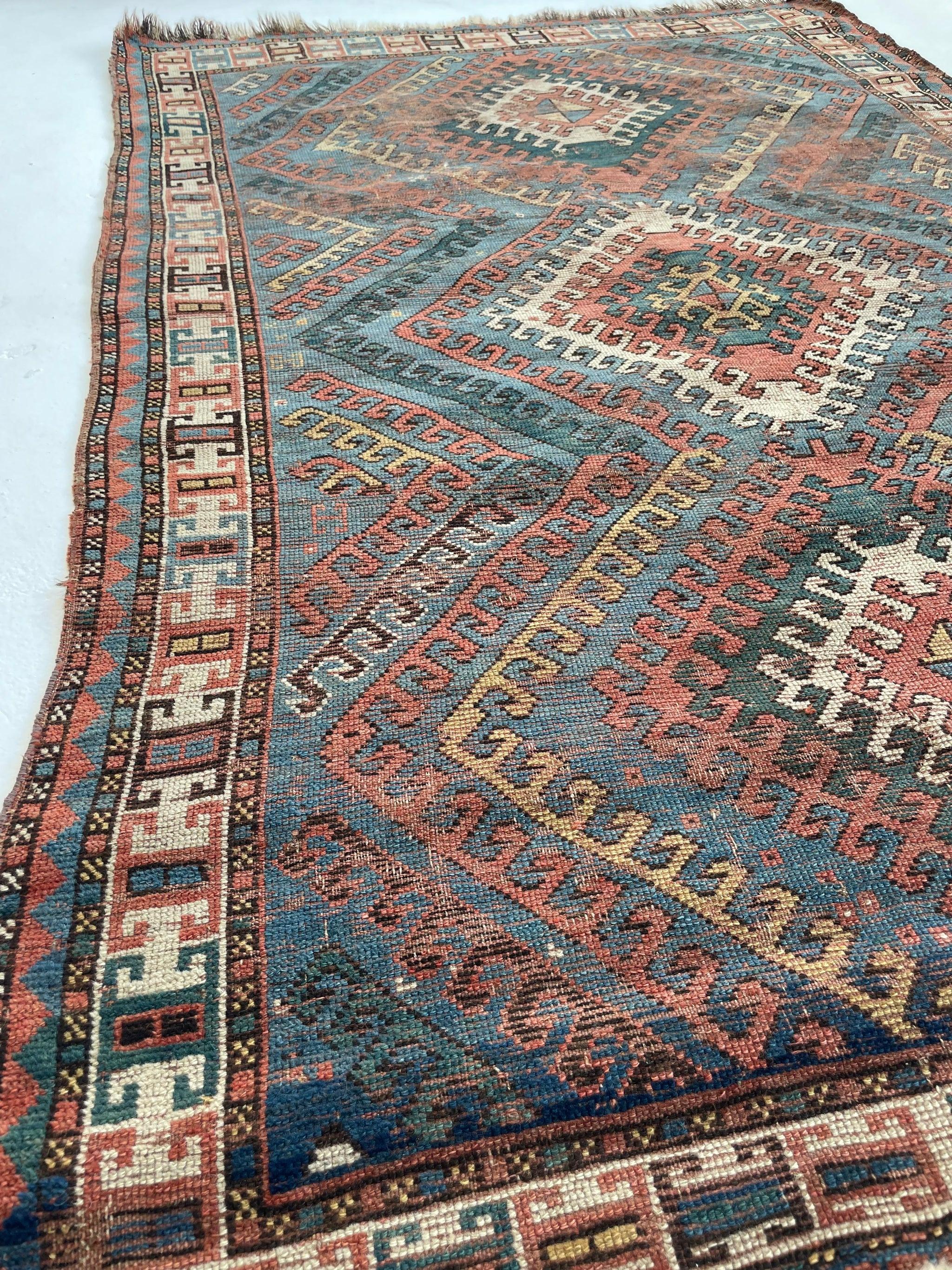 Sensational Sky Blue Antique Caucasian Rug with Ram Horn Outlined Diamonds with Terracotta, Emerald Green, & Wheat Hues

About: This is borderline a collector's item with the very rare sky blue background color - i would say for every 100 rugs