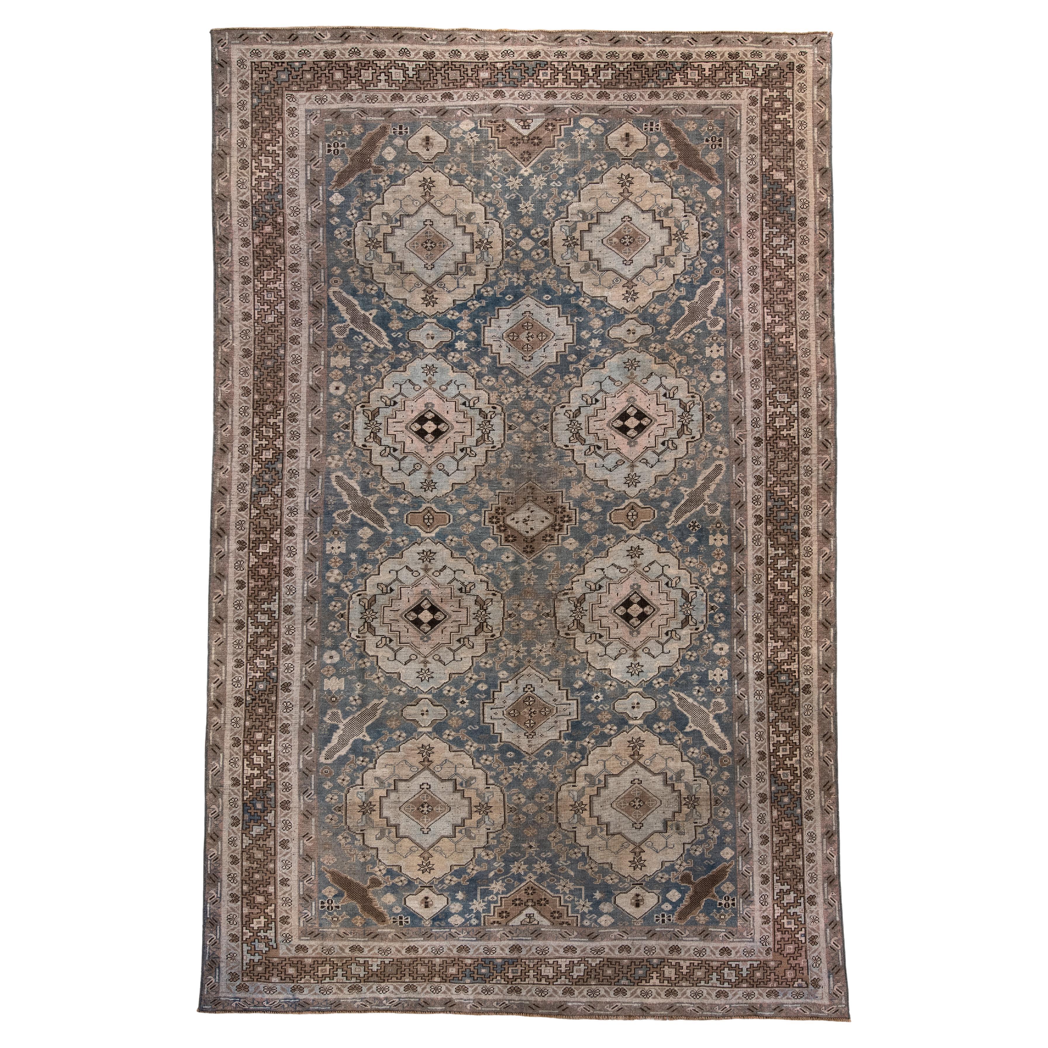 Antique Caucasian Rug with Soft Blue
Camel Medallions.