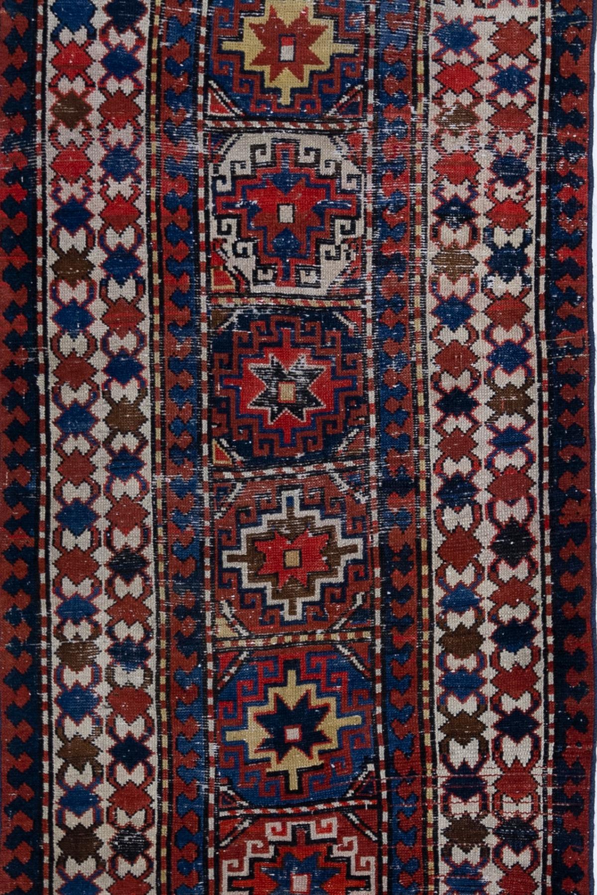 Age: Circa 1910

Colors: red, blue, ivory, gold

Pile: medium

Wear Notes: 5

Material: wool on wool

Antique textile woven in the Caucasus in the earl part of the 20th century. Original colors with beautiful wear.

Vintage rugs are made